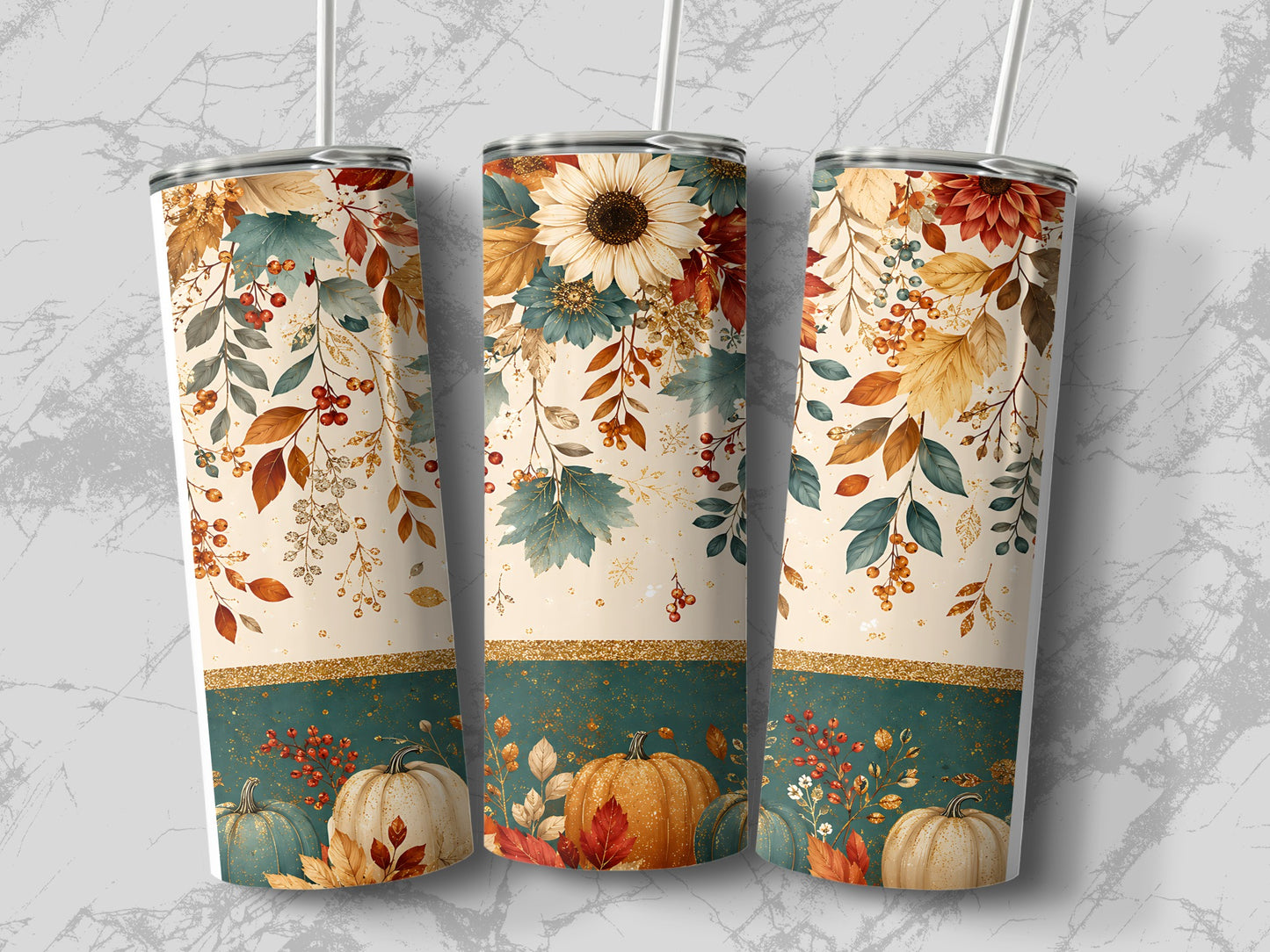 Three tumblers with fall foliage and pumpkin designs on a marble background.