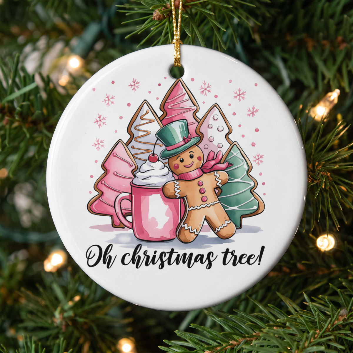 Circular ornament with gingerbread man, mug, and Christmas tree cookies, reads "Oh christmas tree!".