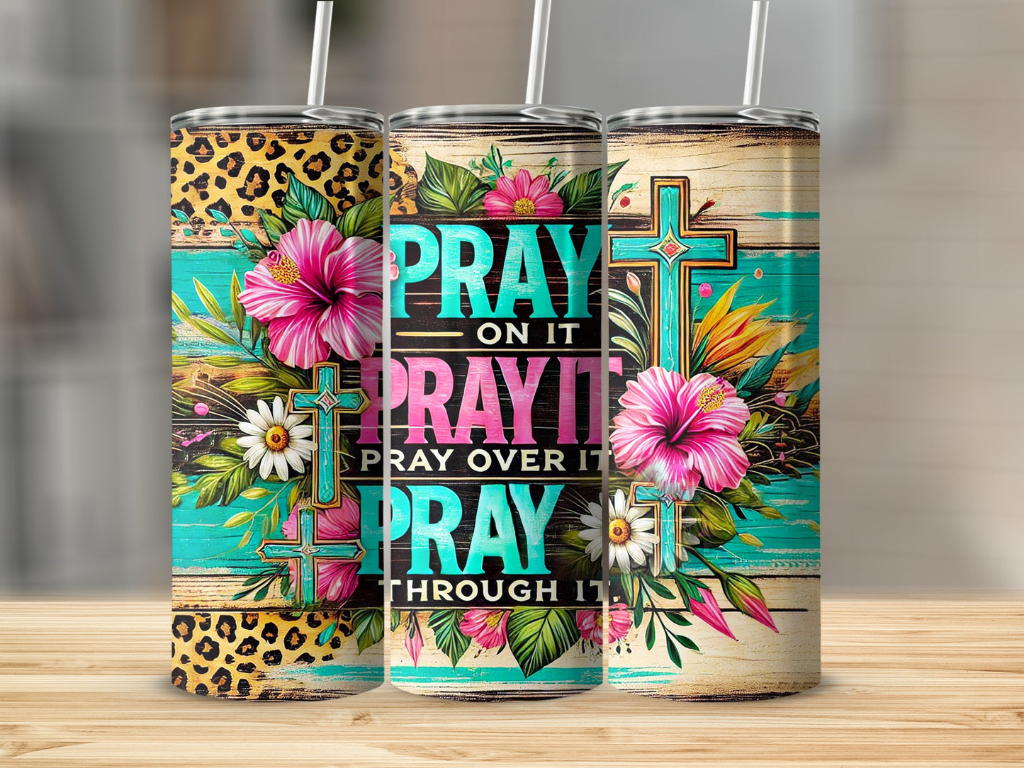 Pink and teal floral tumbler with "Pray on it, pray over it, pray through it" text.