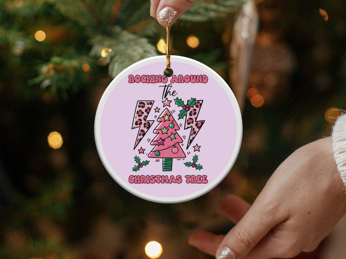 Round Christmas ornament with pink tree, lightning bolts and "Rocking Around The Christmas Tree" text.