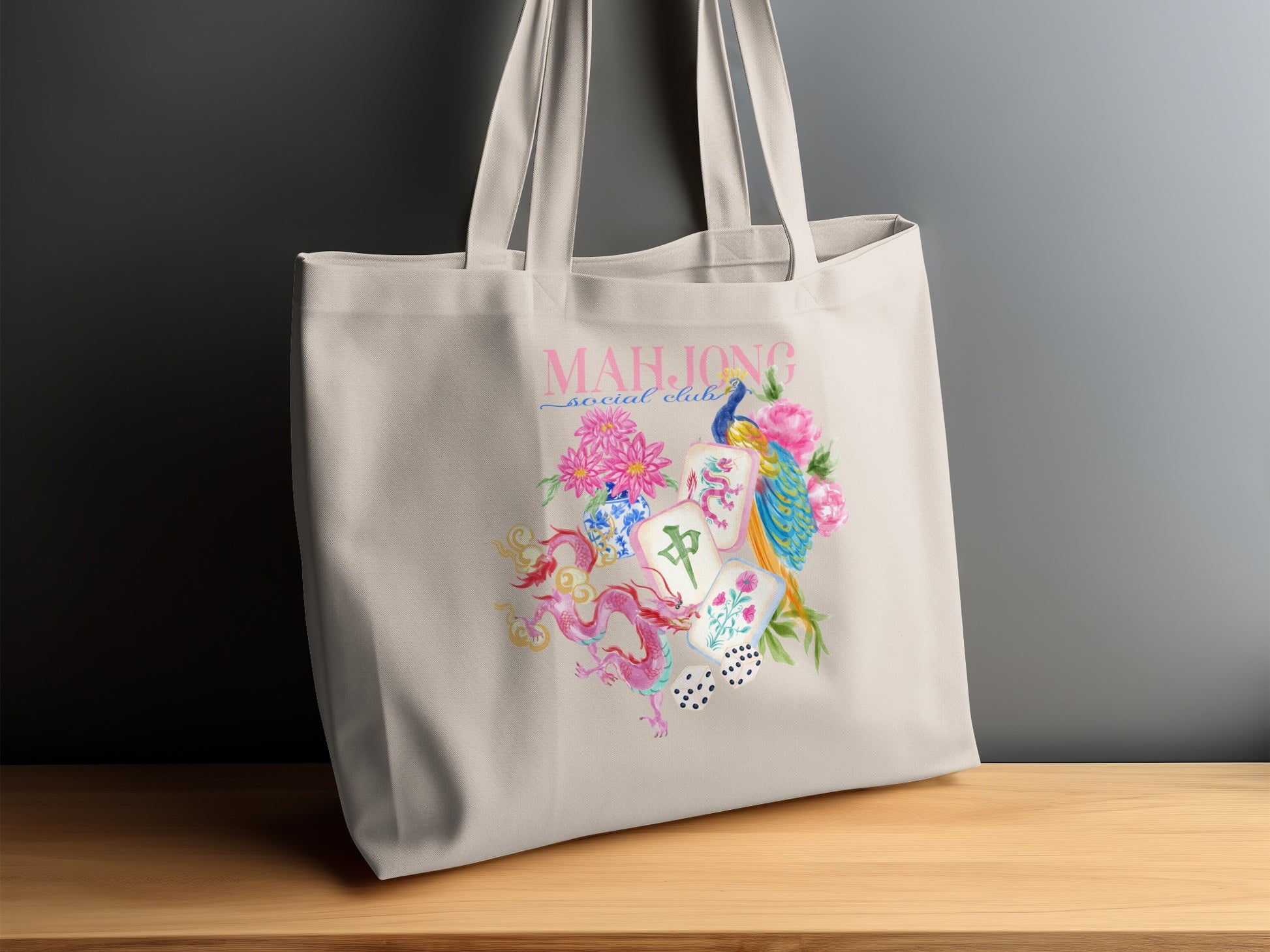 Tote bag with pink text "Mahjong" and watercolor art of dragon, peacock, flowers, and mahjong tiles.