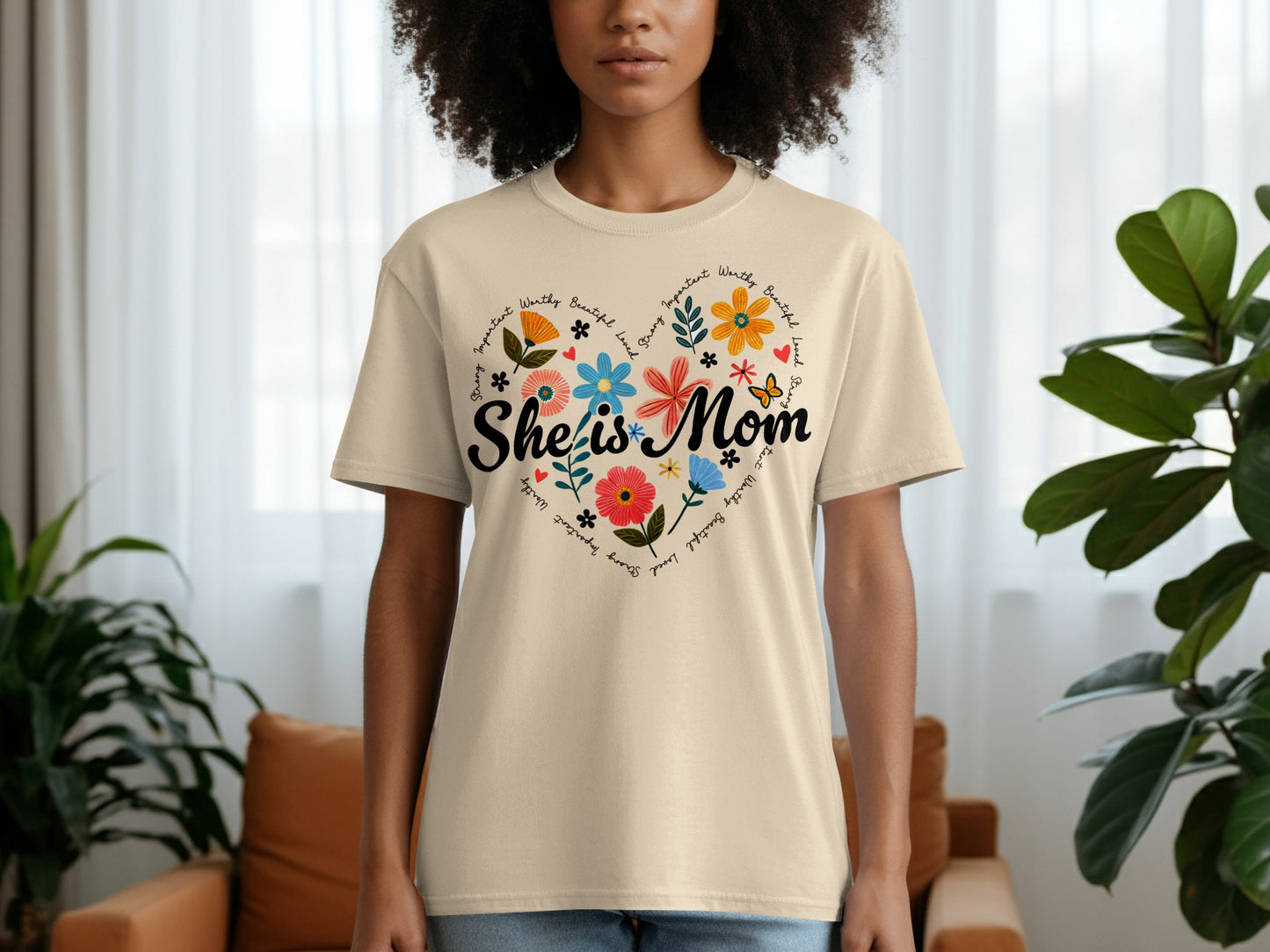 Cream t-shirt with "She is Mom" inside a floral heart design.