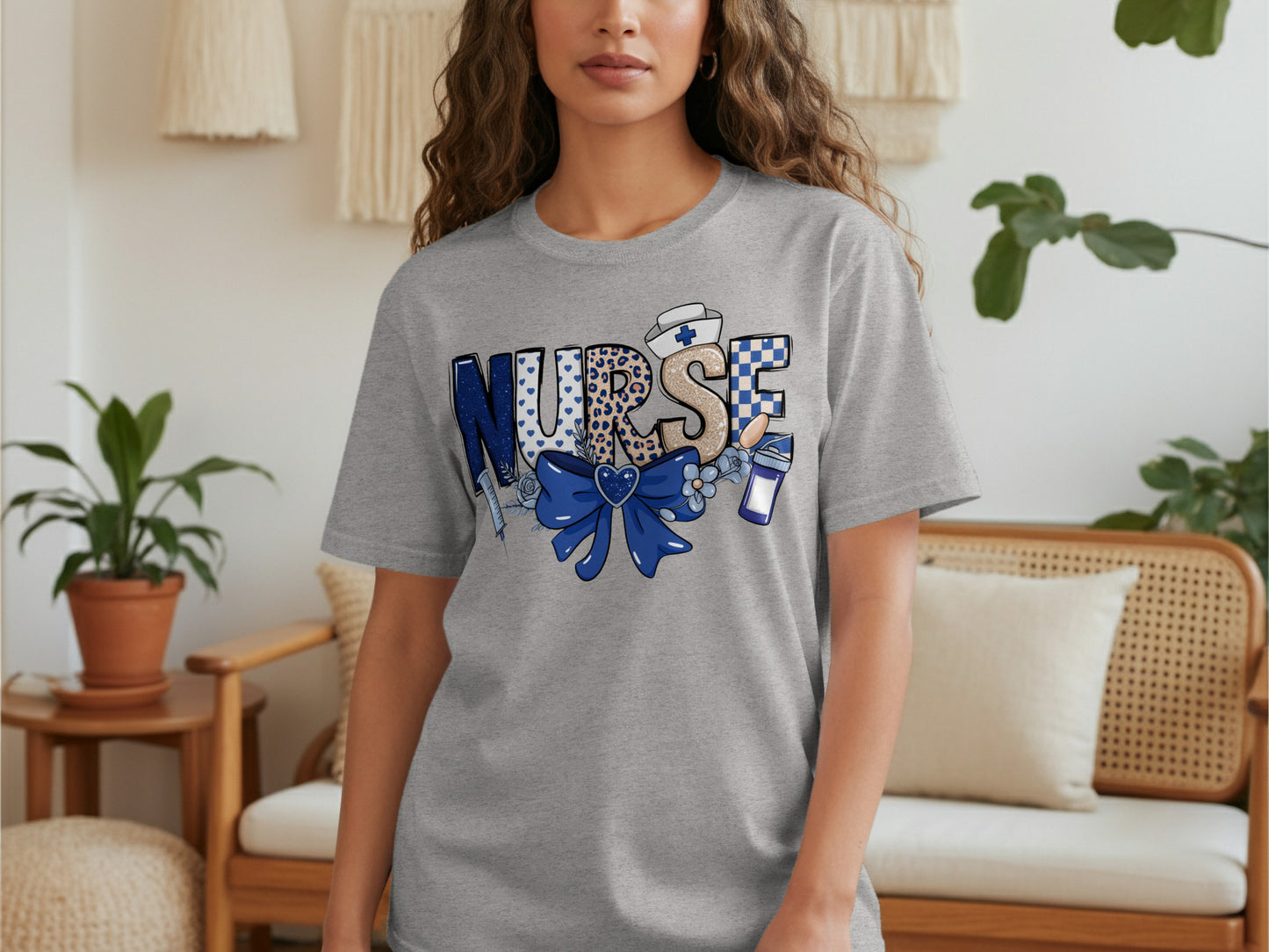 Gray t-shirt with "NURSE" text featuring medical icons and blue bow.