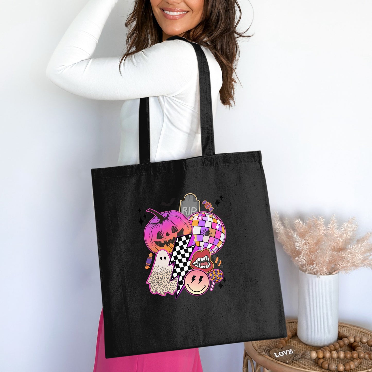 Black tote bag with colorful Halloween graphic including pumpkin, ghost, disco ball, and lips.