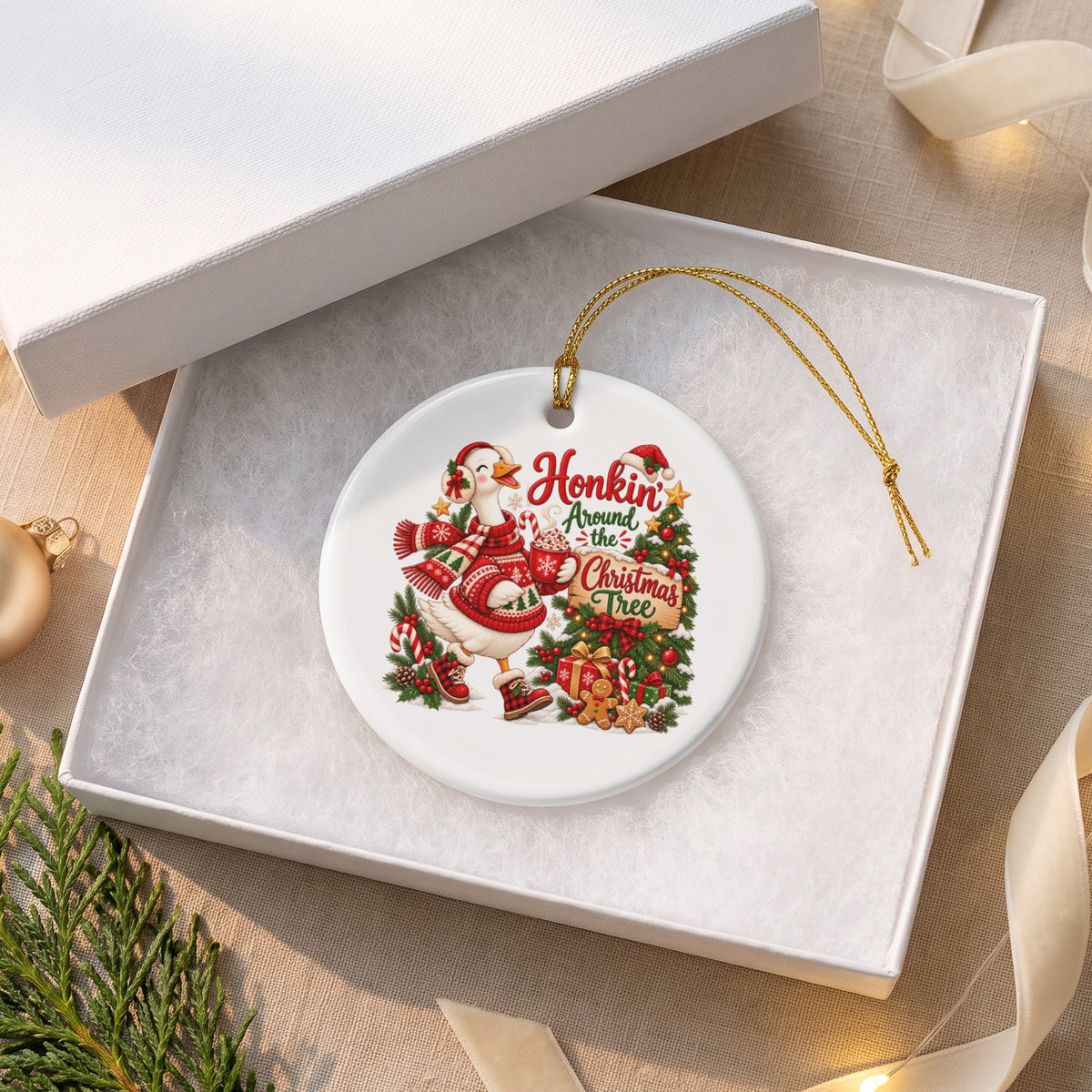 Round Christmas ornament with a goose holding hot chocolate, saying "Honkin' Around the Christmas Tree".