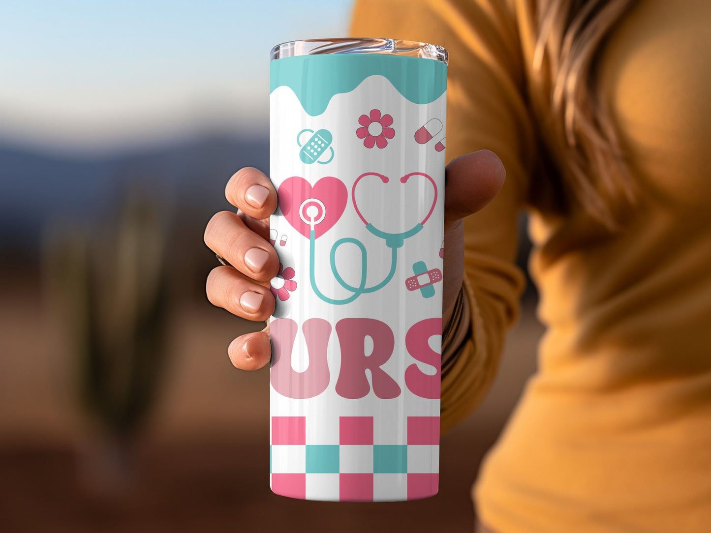 Pink and blue nurse themed tumbler with stethoscope, heart, and flowers.