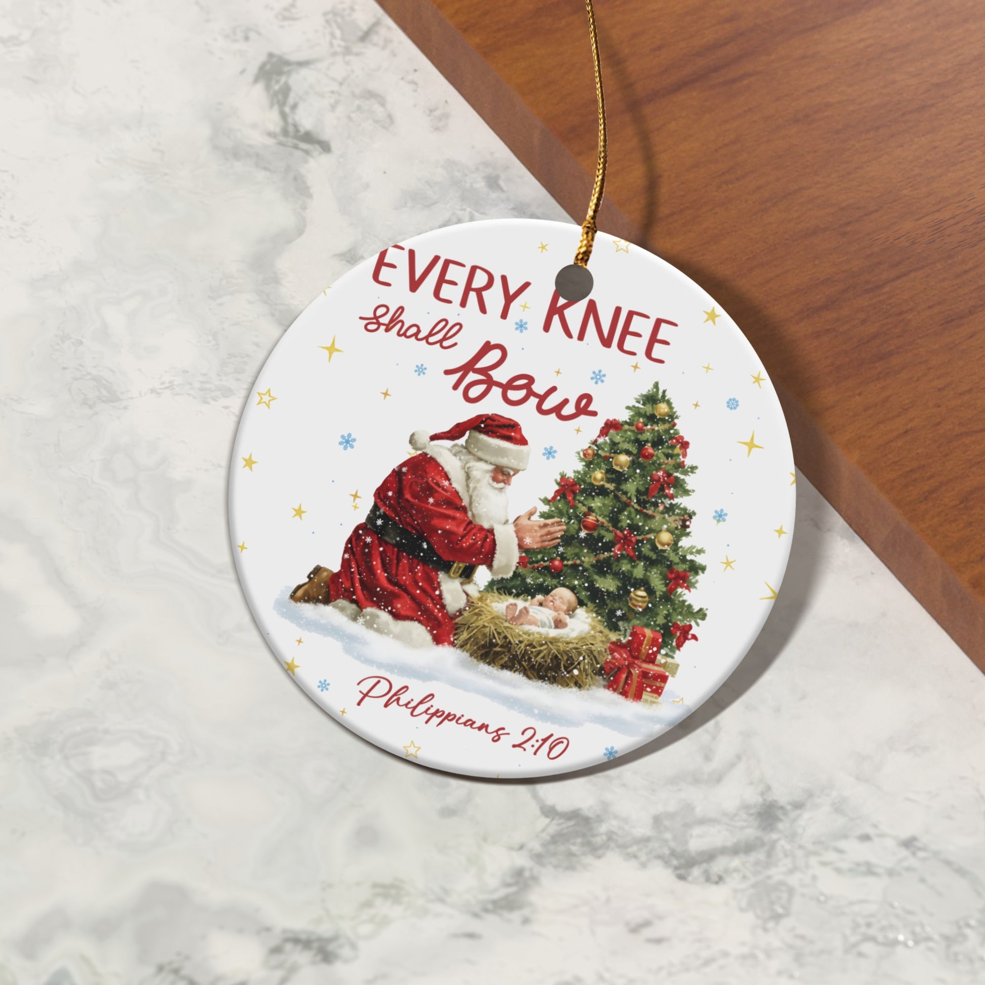 Ornament featuring Santa kneeling before a nativity scene with text "Every Knee Shall Bow."