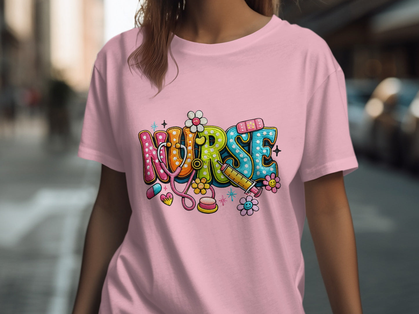 Nurse text art with medical symbols on a pink t-shirt.