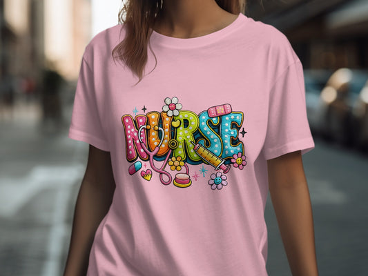 Nurse text art with medical symbols on a pink t-shirt.