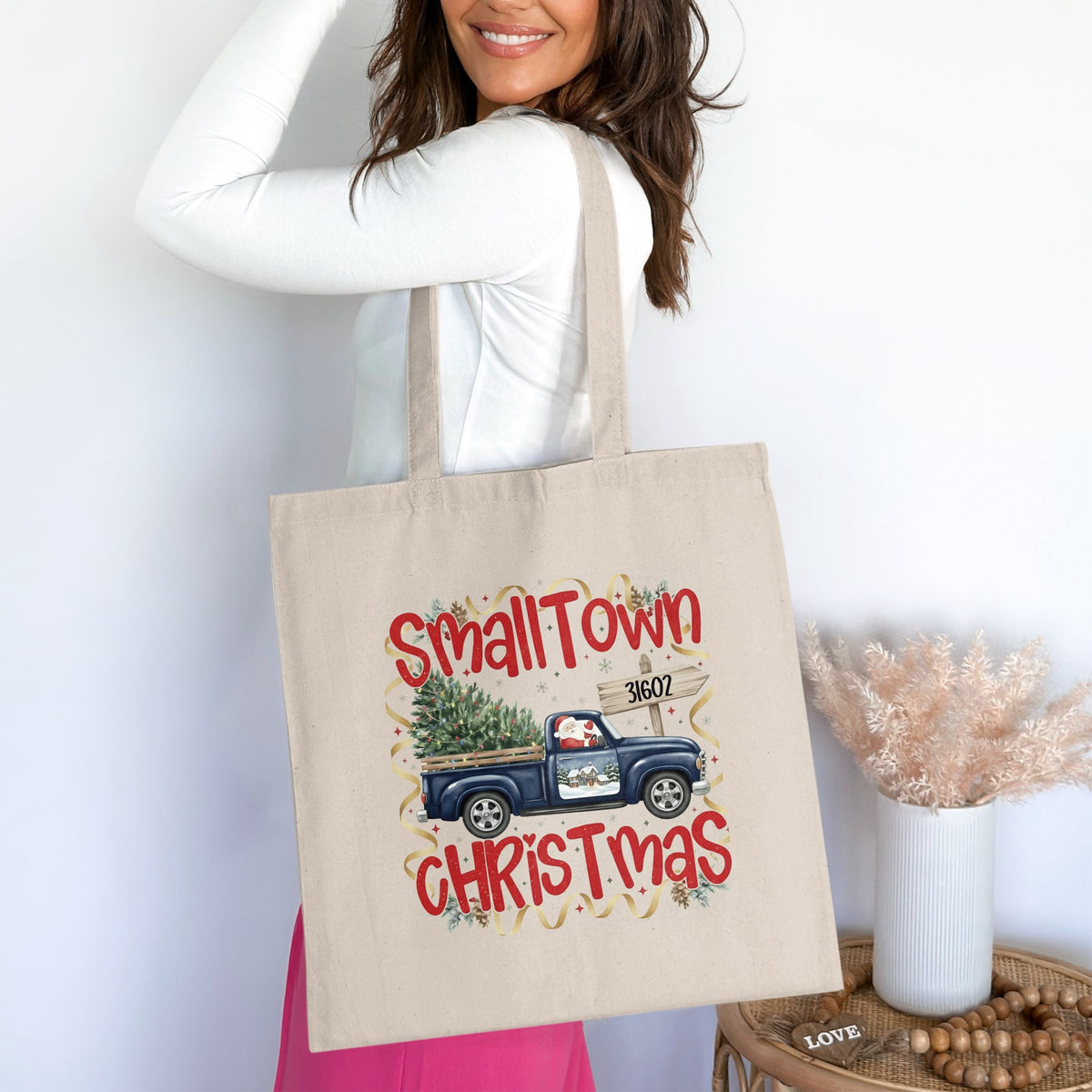 Canvas tote bag with "SmallTown Christmas" and a blue truck carrying a tree.
