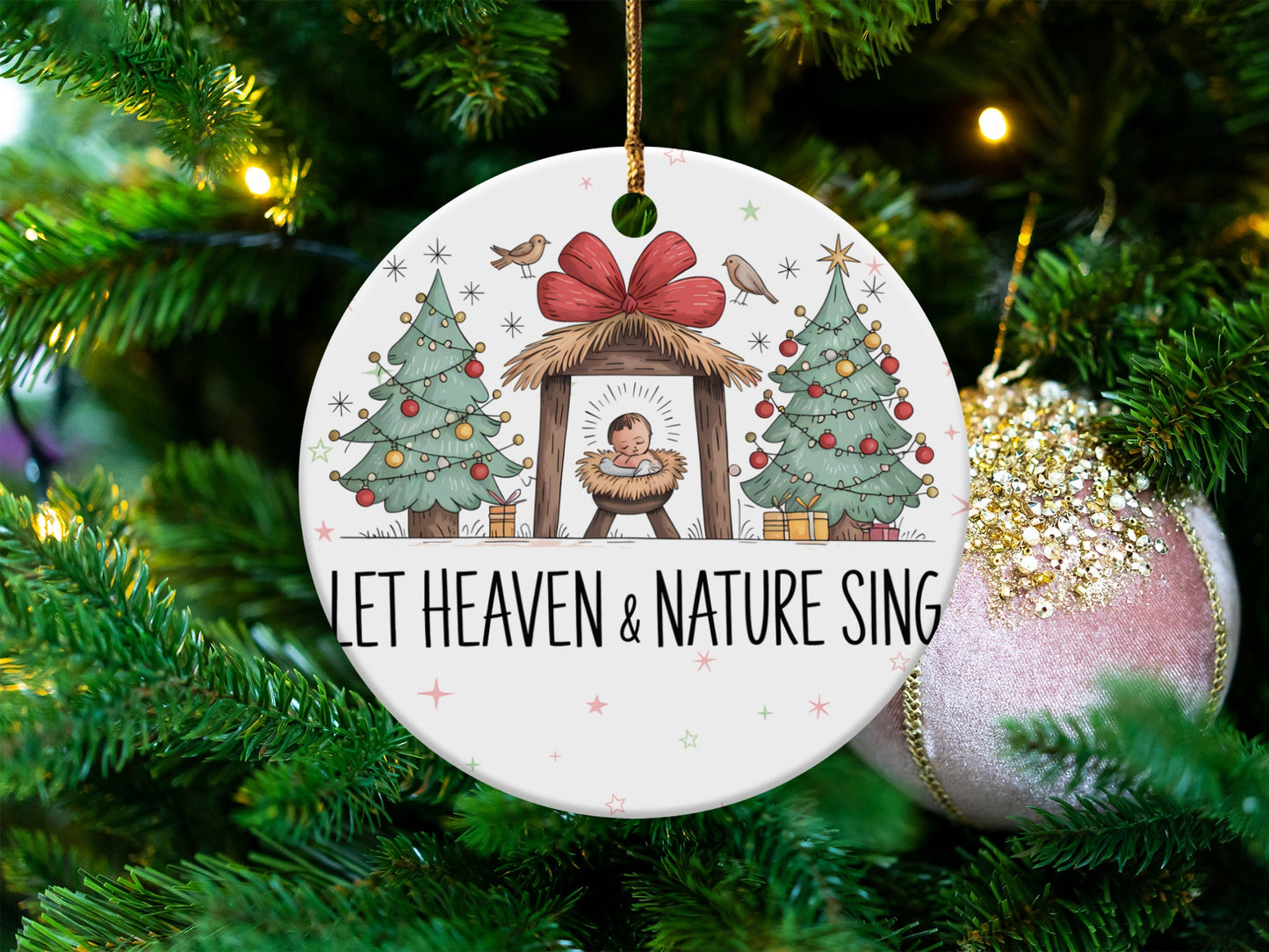 Nativity scene with baby Jesus, Christmas trees, and text "LET HEAVEN & NATURE SING".