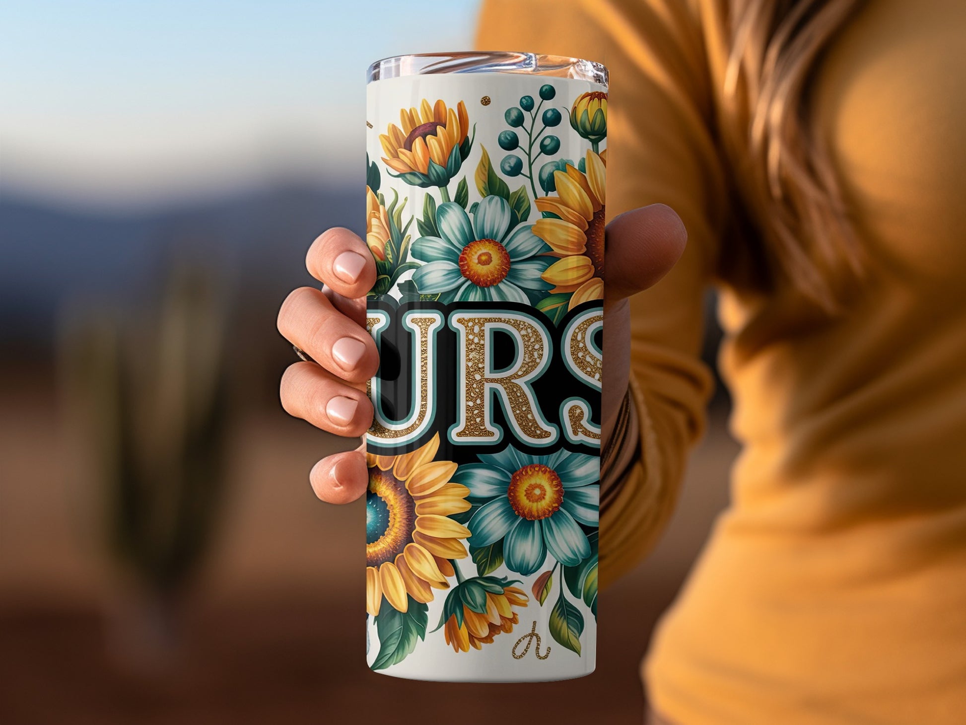 Tumbler with sunflowers, daisies, and "NURSE" in glitter lettering.