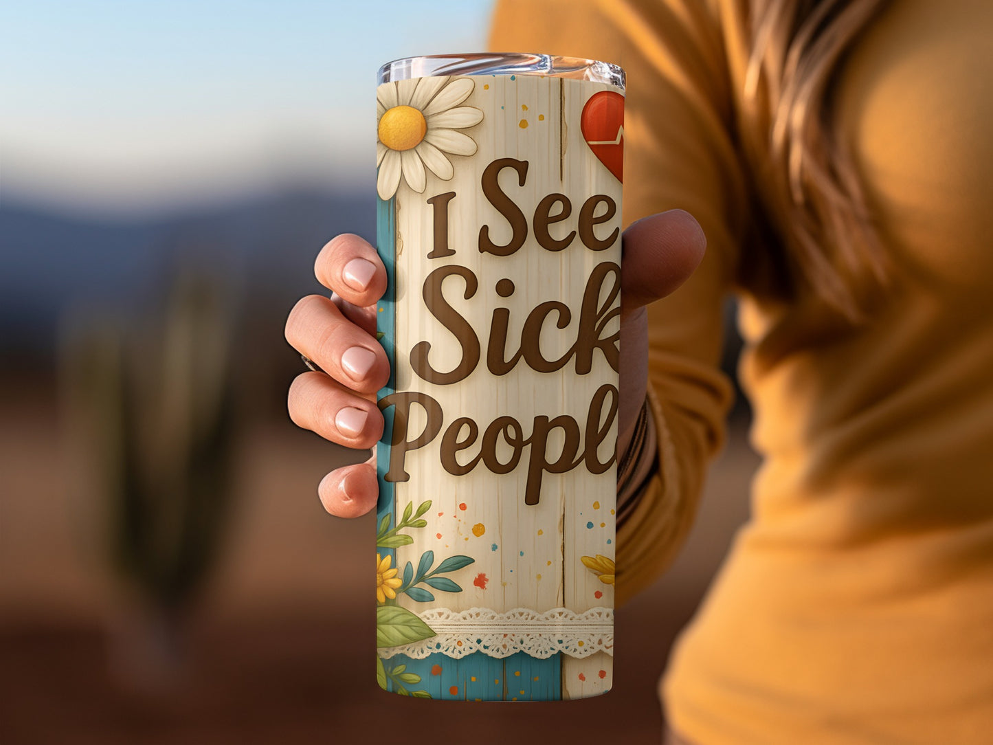 Tumbler with "I See Sick People" text, flowers, and a heart graphic.