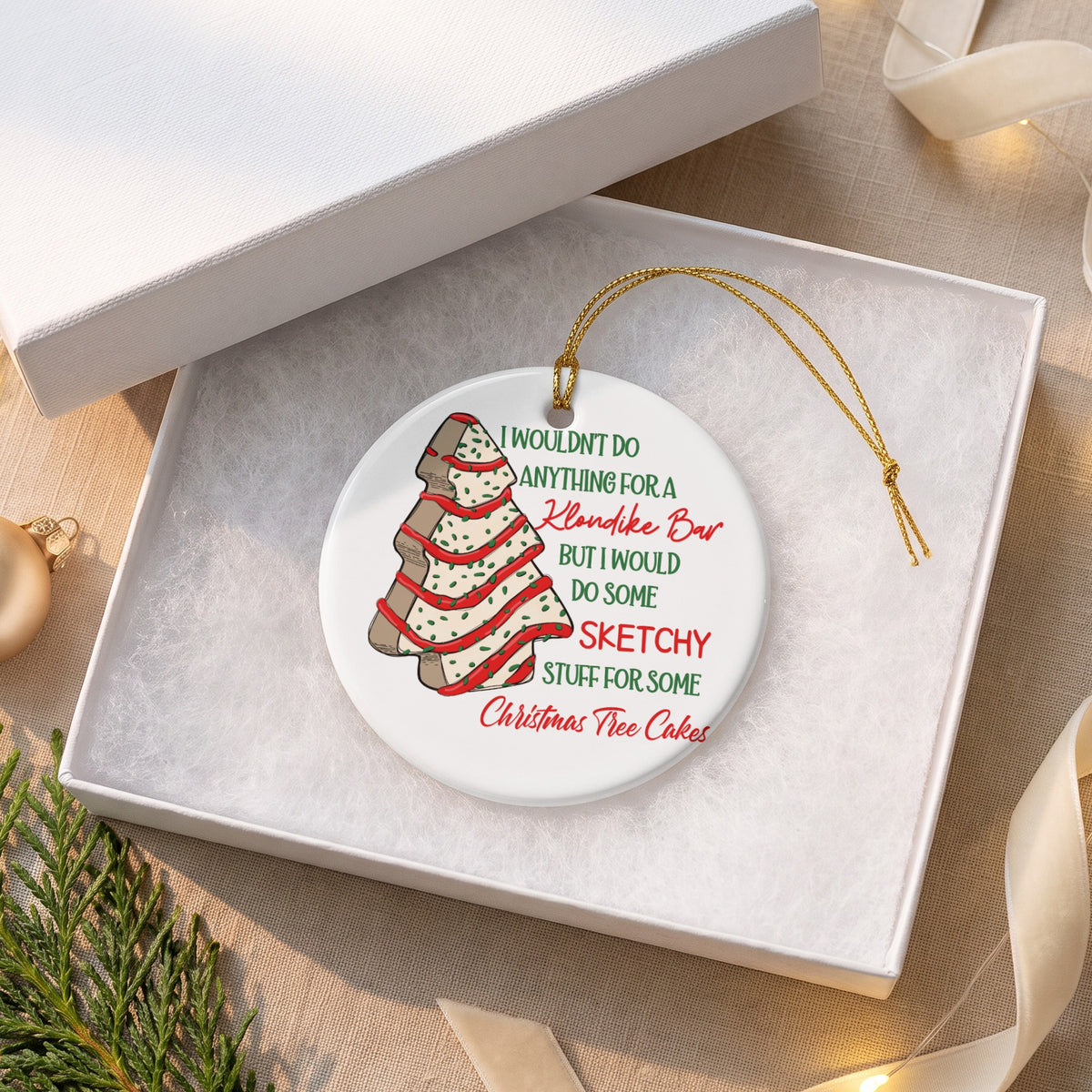 Round ornament with Christmas tree cake illustration and text about Klondike Bars and cakes.
