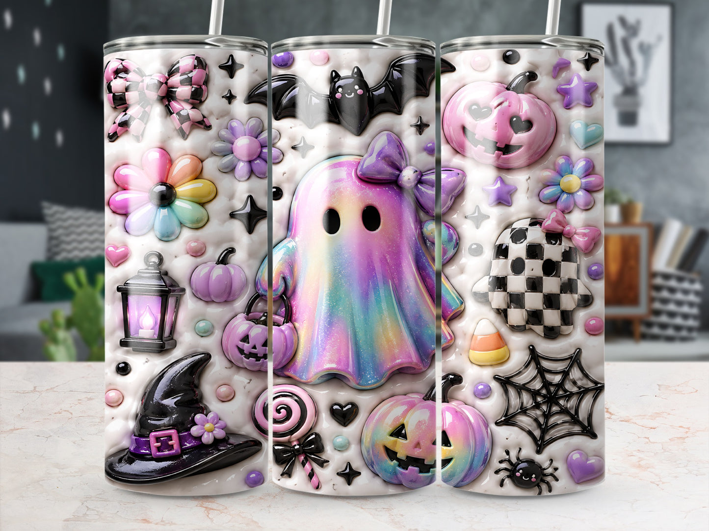 Tumbler with pastel Halloween decorations including a ghost, pumpkins, bat, and witch hat.