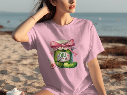 Pink t-shirt with jar of pickles that reads "Dill with it."
