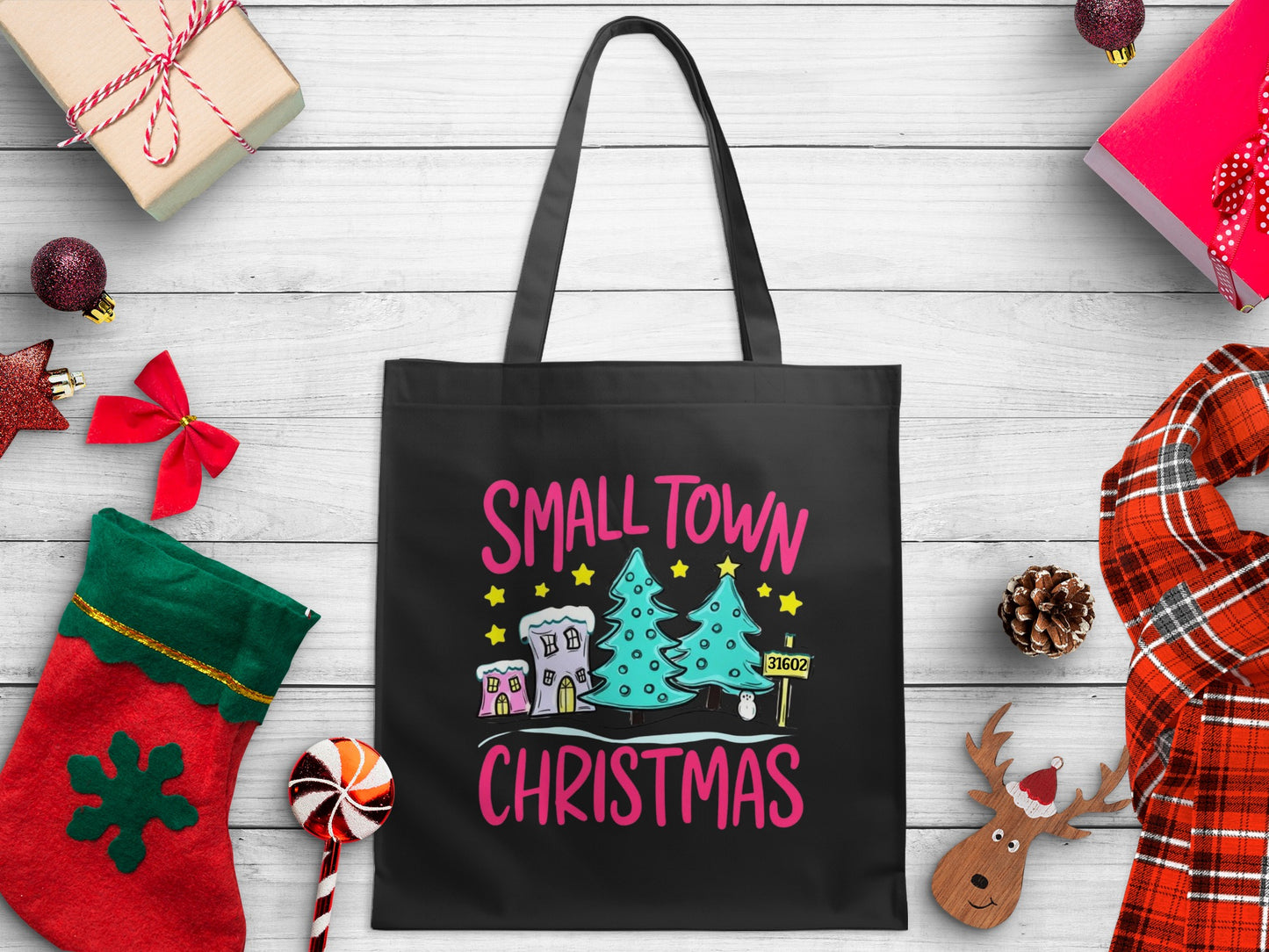 Black tote bag with "Small Town Christmas" text and festive holiday graphic.