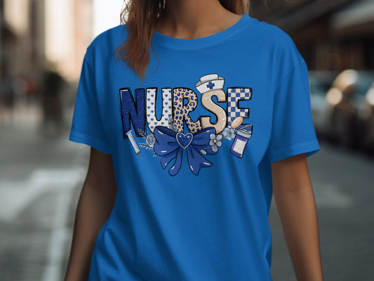 Blue t-shirt with "NURSE" text design featuring stethoscope, heart, and nurse's cap.