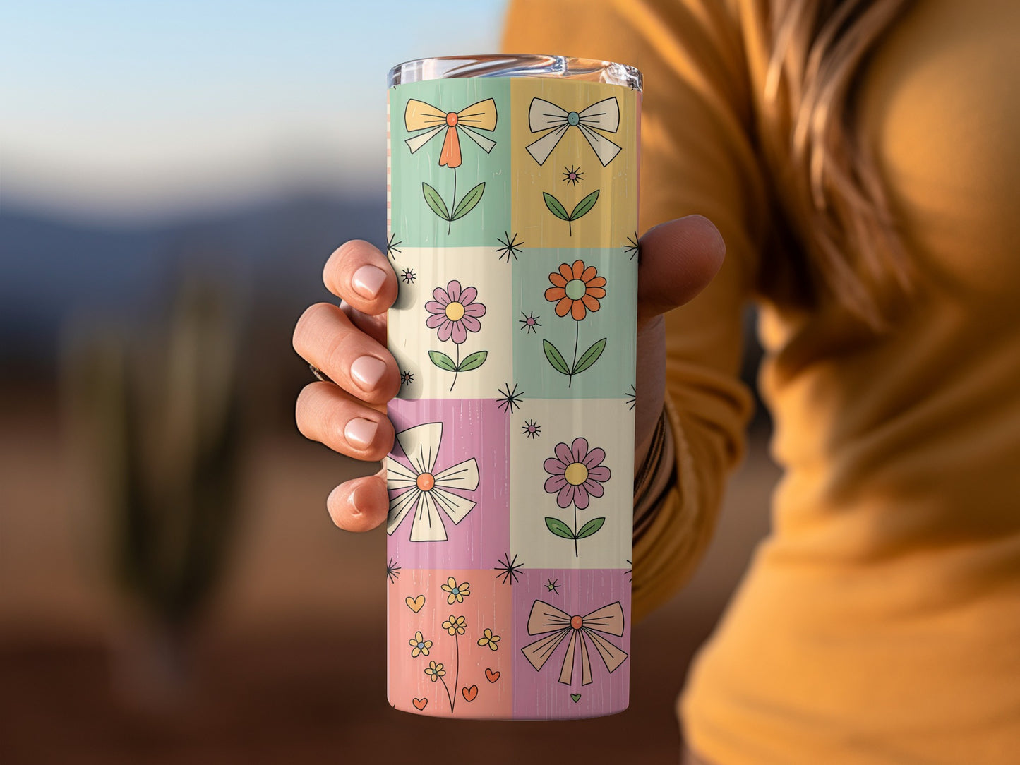 Grid pattern tumbler with flowers and bows.