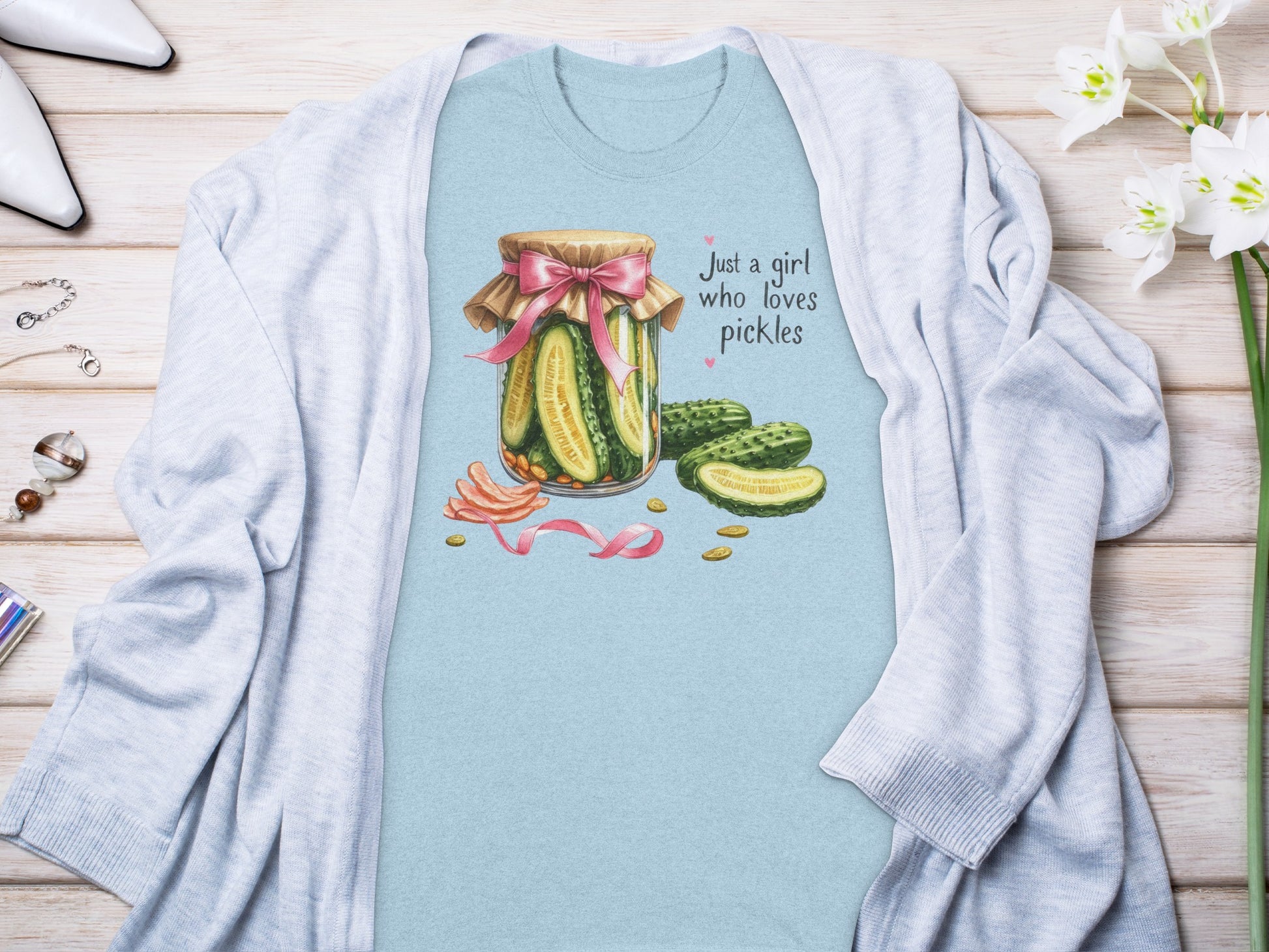 Light blue t-shirt with a watercolor illustration of a pickle jar and slices.