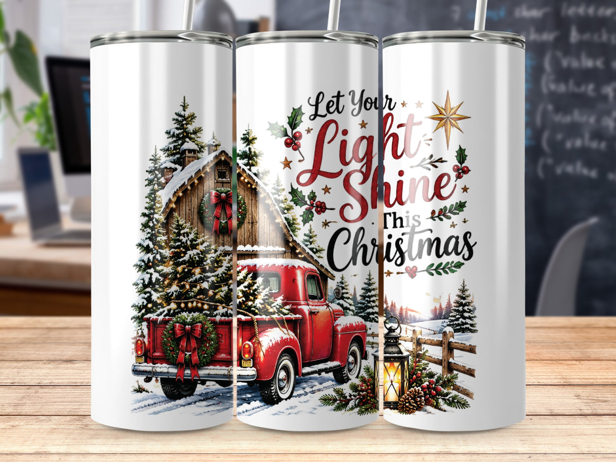Three white tumblers with a Christmas design featuring a red truck carrying a tree and the text "Let Your Light Shine This Christmas."