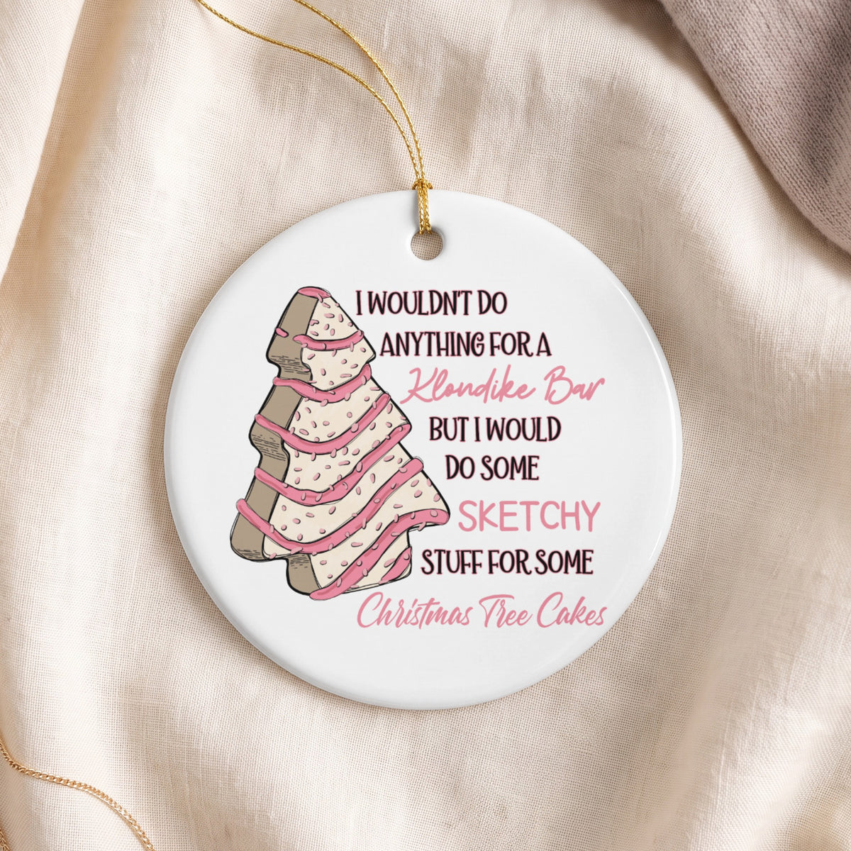 Round ornament with tree cookie graphic and text: "I wouldn't do anything for a Klondike Bar but I would do some sketchy stuff for some Christmas tree cakes."