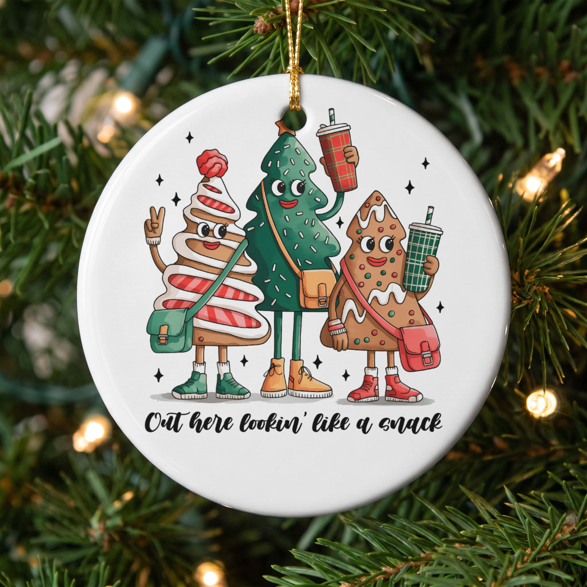 Three cartoon Christmas trees with faces and drinks read "Out here lookin' like a snack".