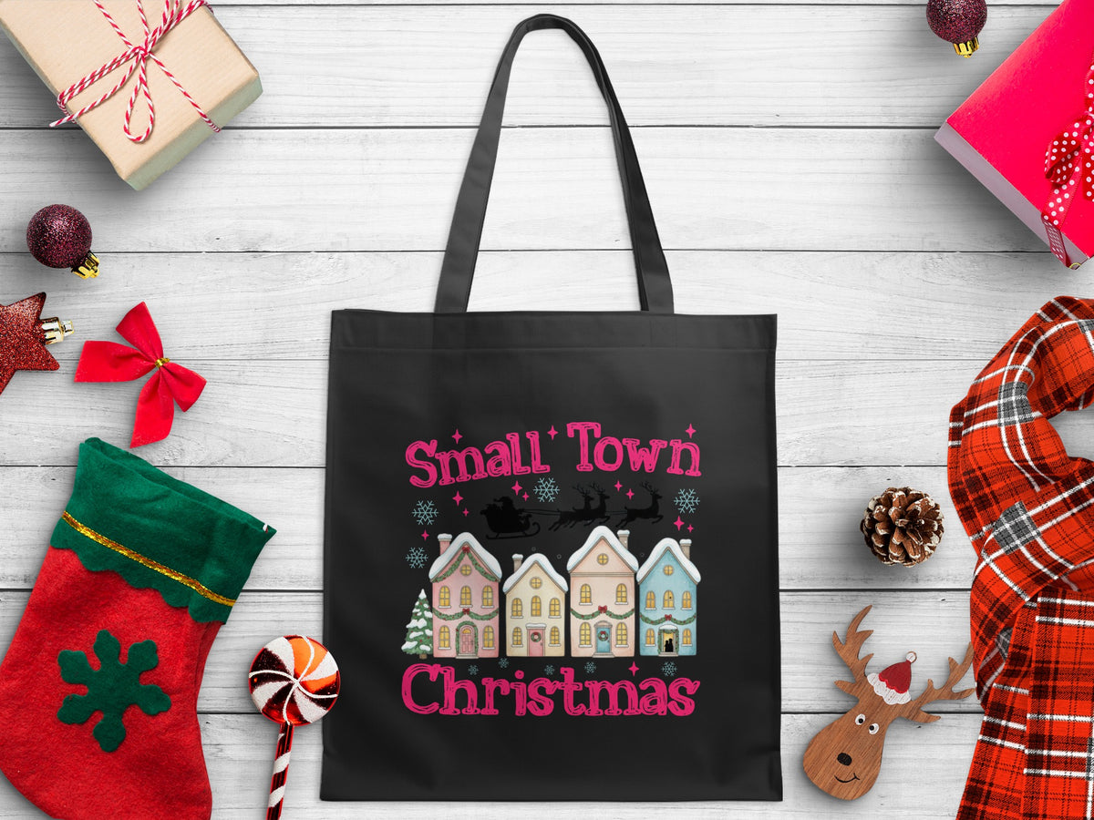 Black tote bag with "Small Town Christmas" text and holiday graphic.