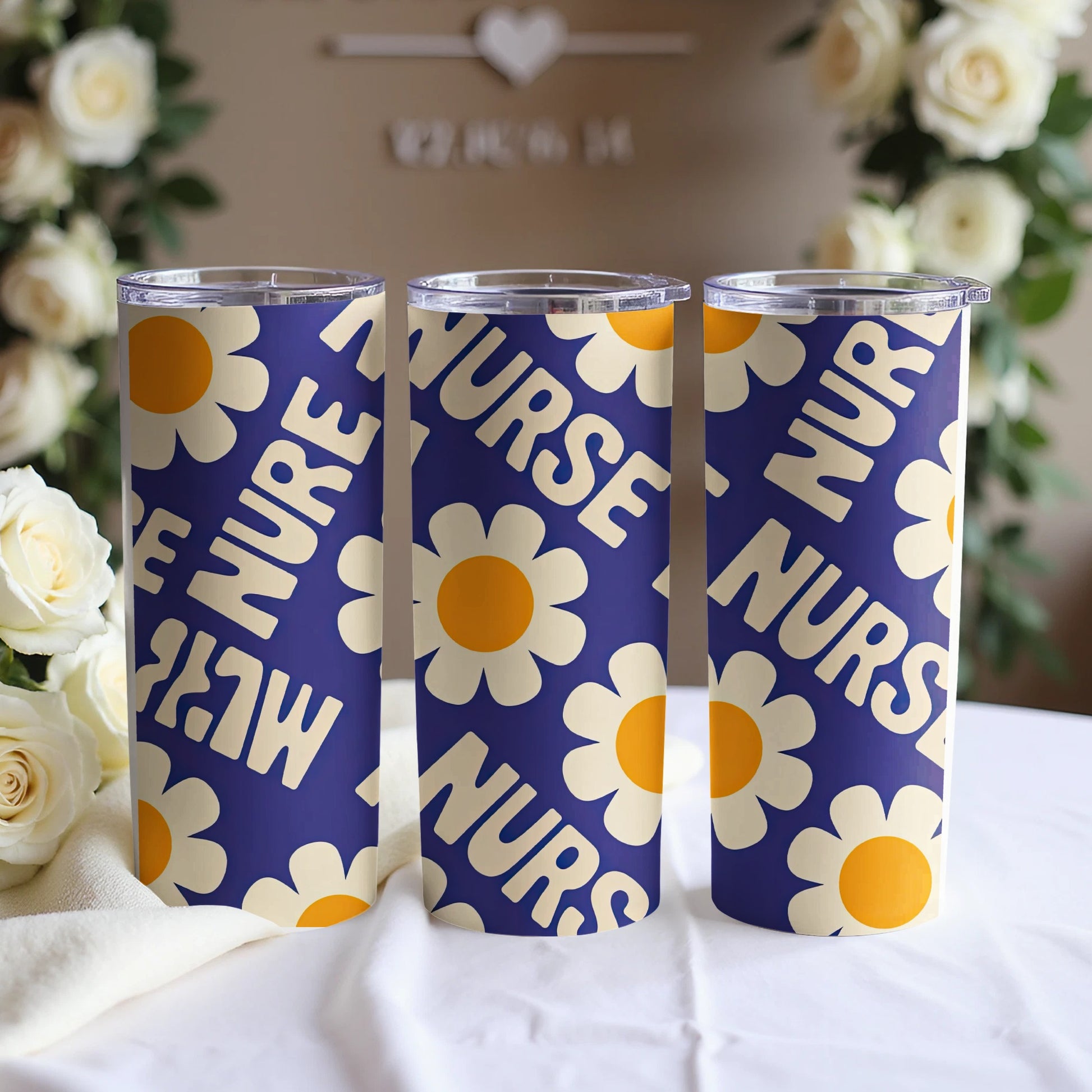Three nurse tumblers with a blue background and yellow floral pattern.