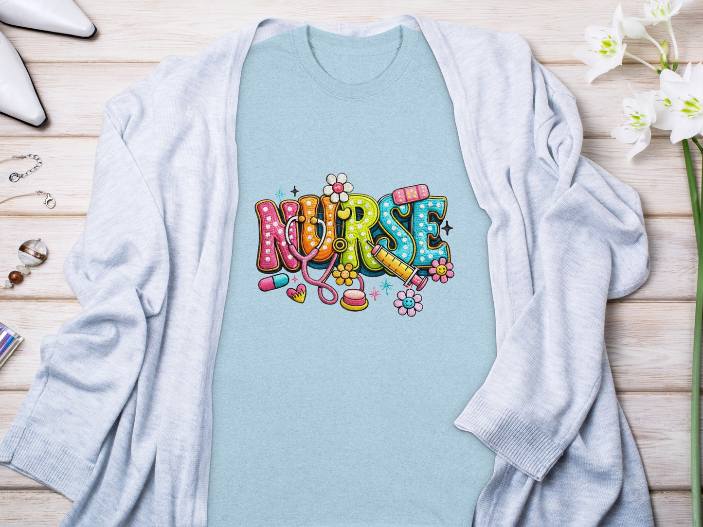 Light blue t-shirt with colorful "Nurse" text and medical icons.