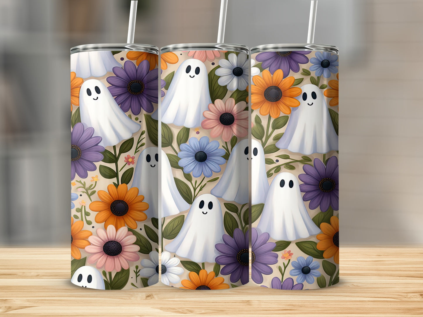 Three tumblers with ghosts and floral pattern on a light background.