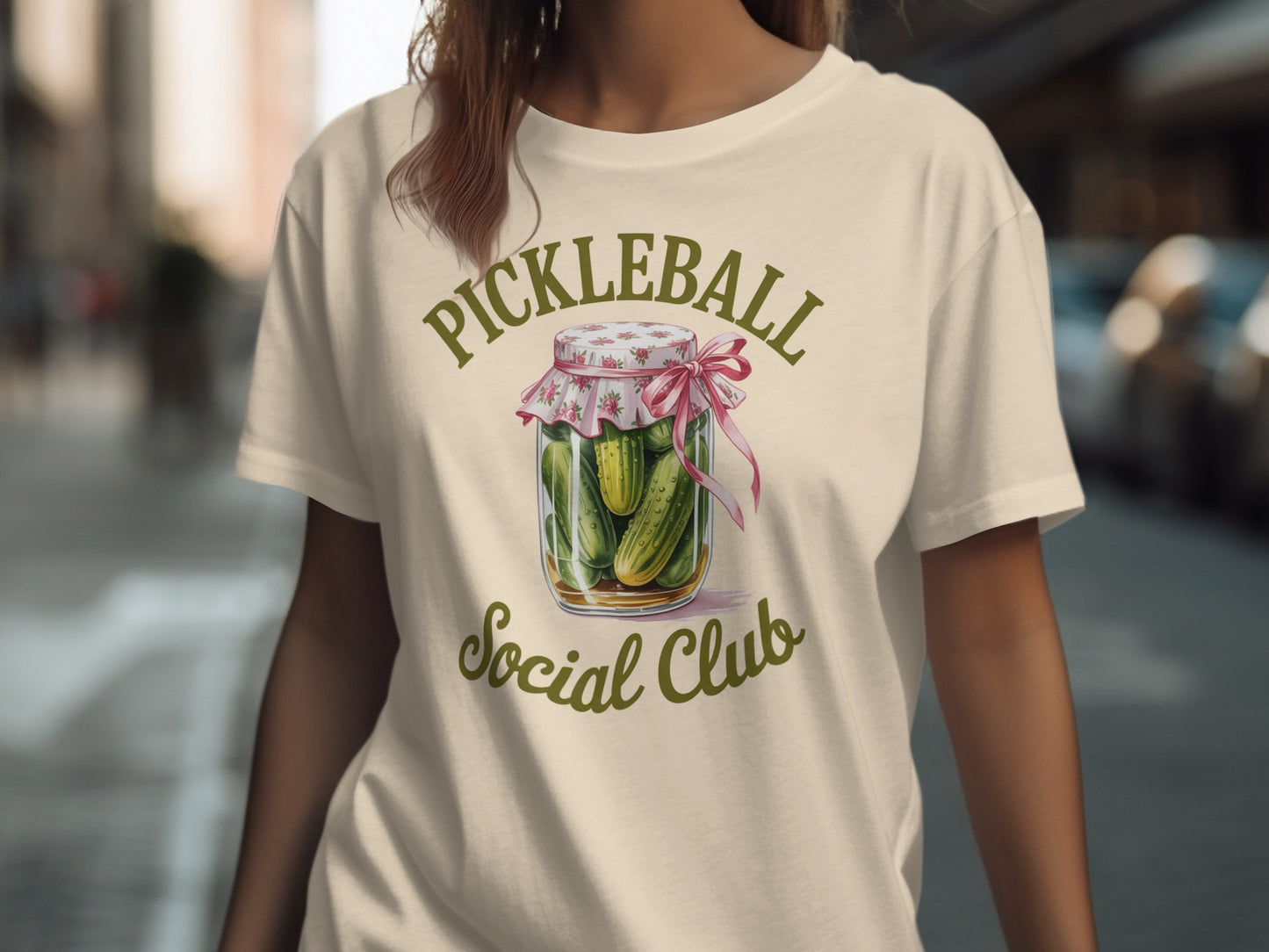 T-shirt with a jar of pickles and "Pickleball Social Club" text.