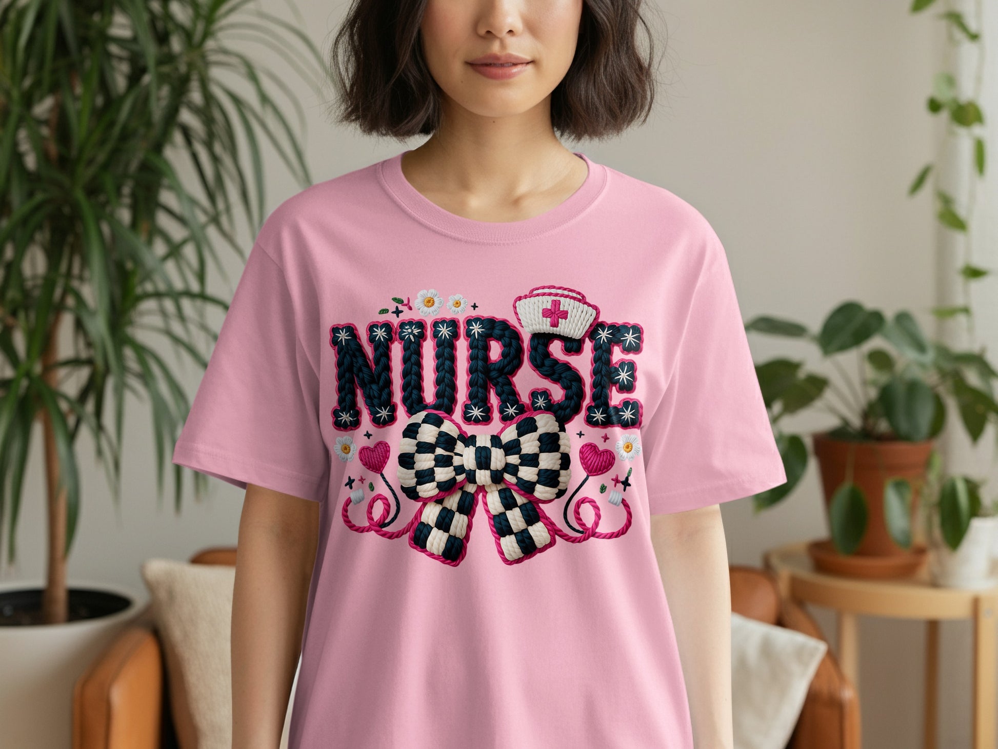 Pink t-shirt with "NURSE" text, medical cross, and bow design.