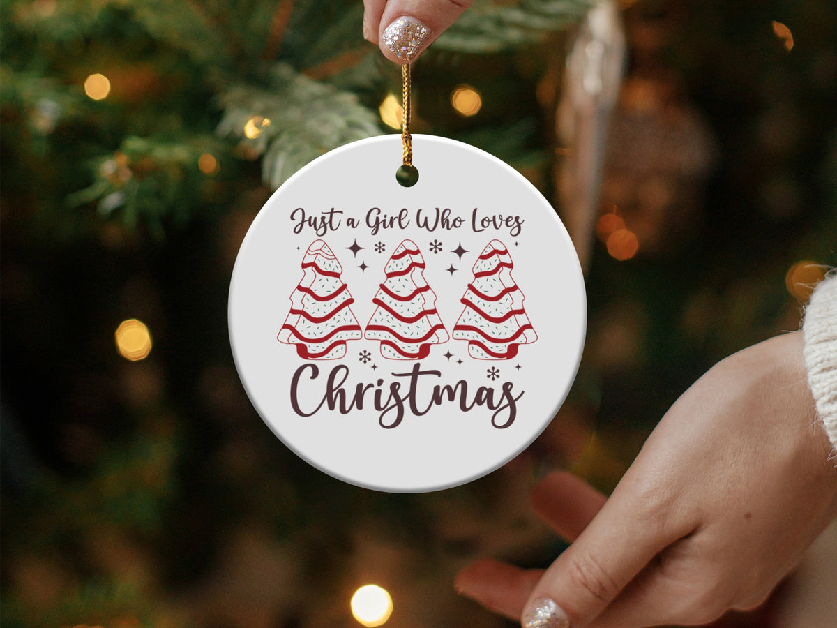 Round ornament with trees saying "Just a Girl Who Loves Christmas."