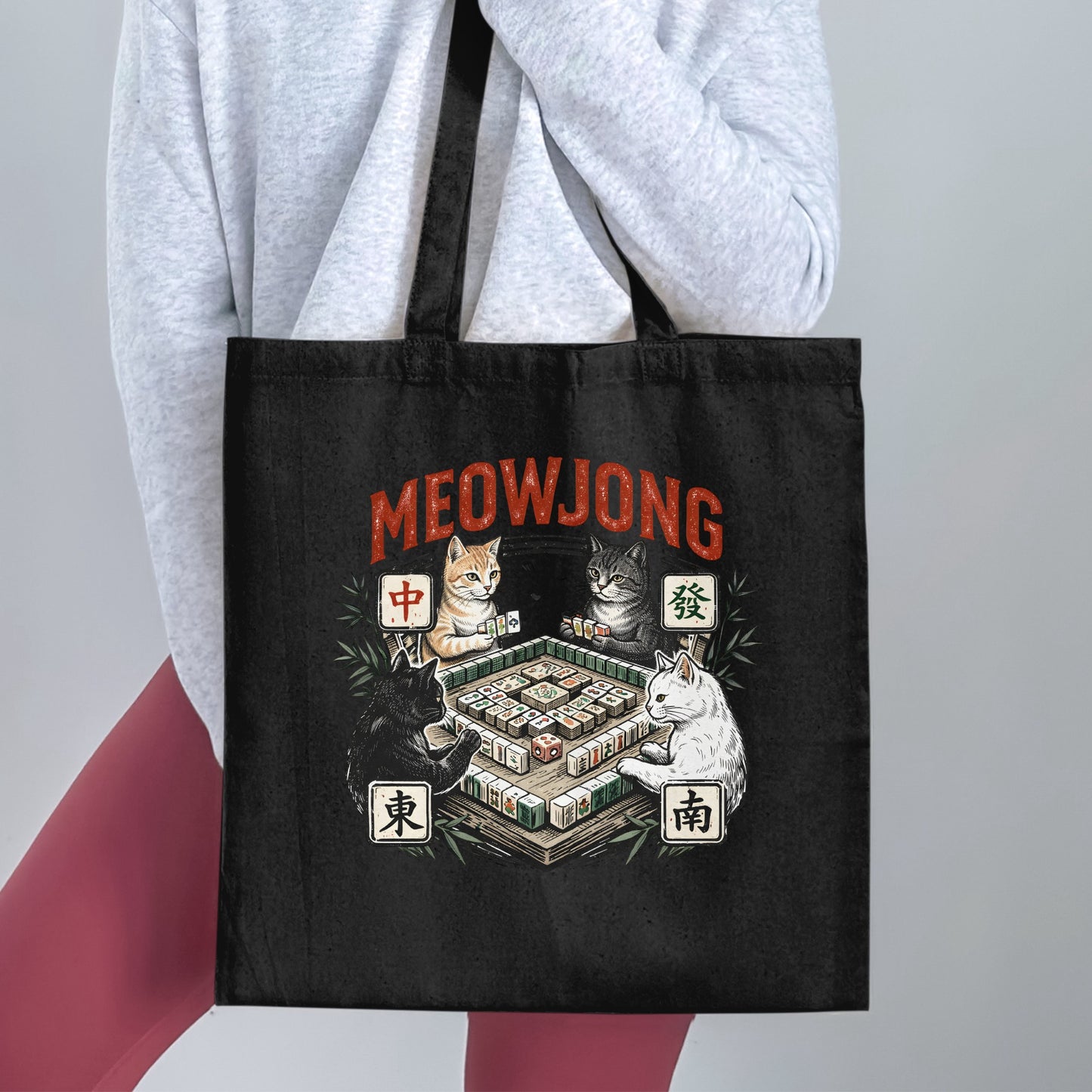 Tote bag with four cats playing mahjong with text "MEOWJONG" above.