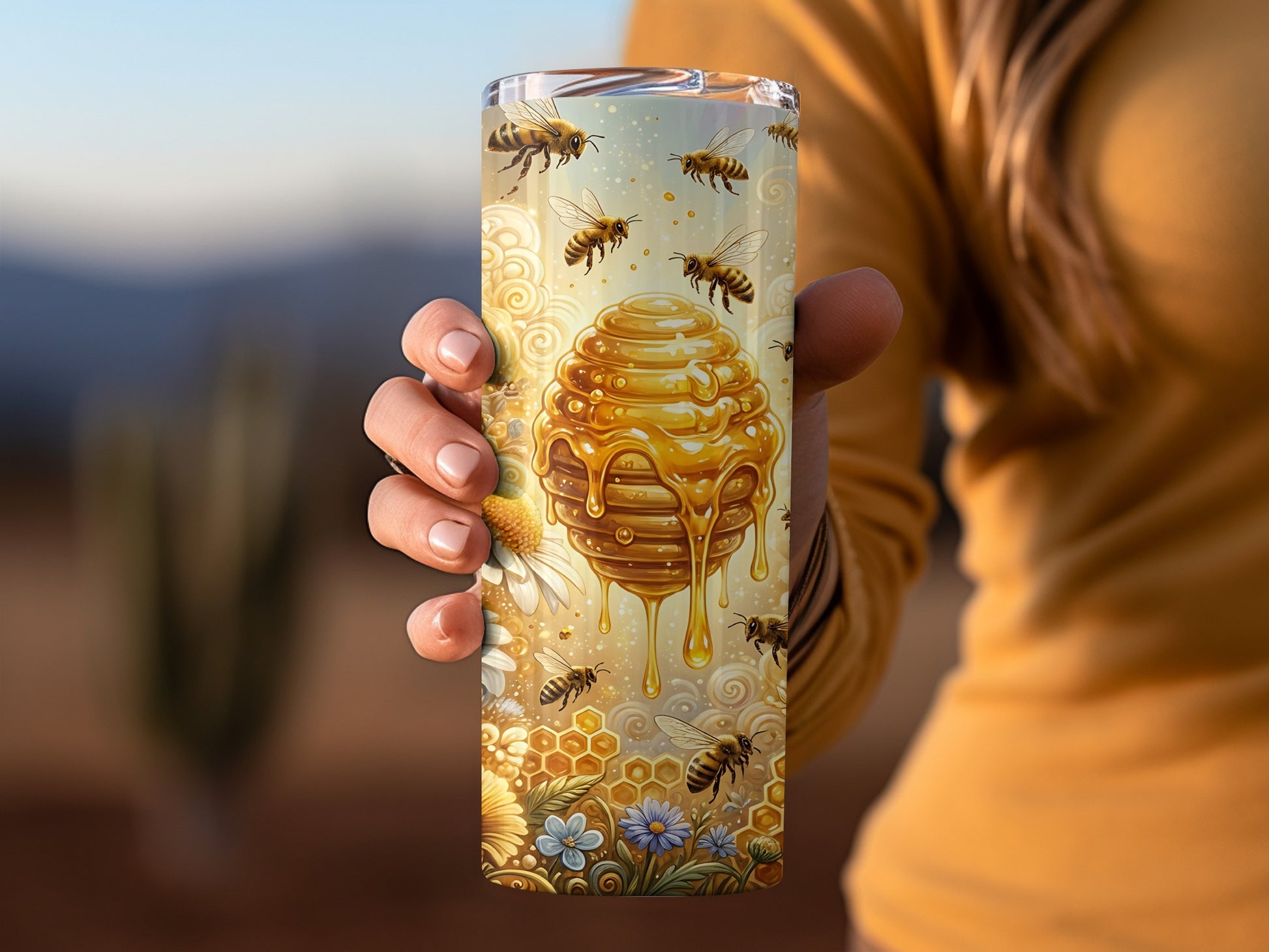 Gold honeycomb dripping honey with bees and flowers, held by a person.