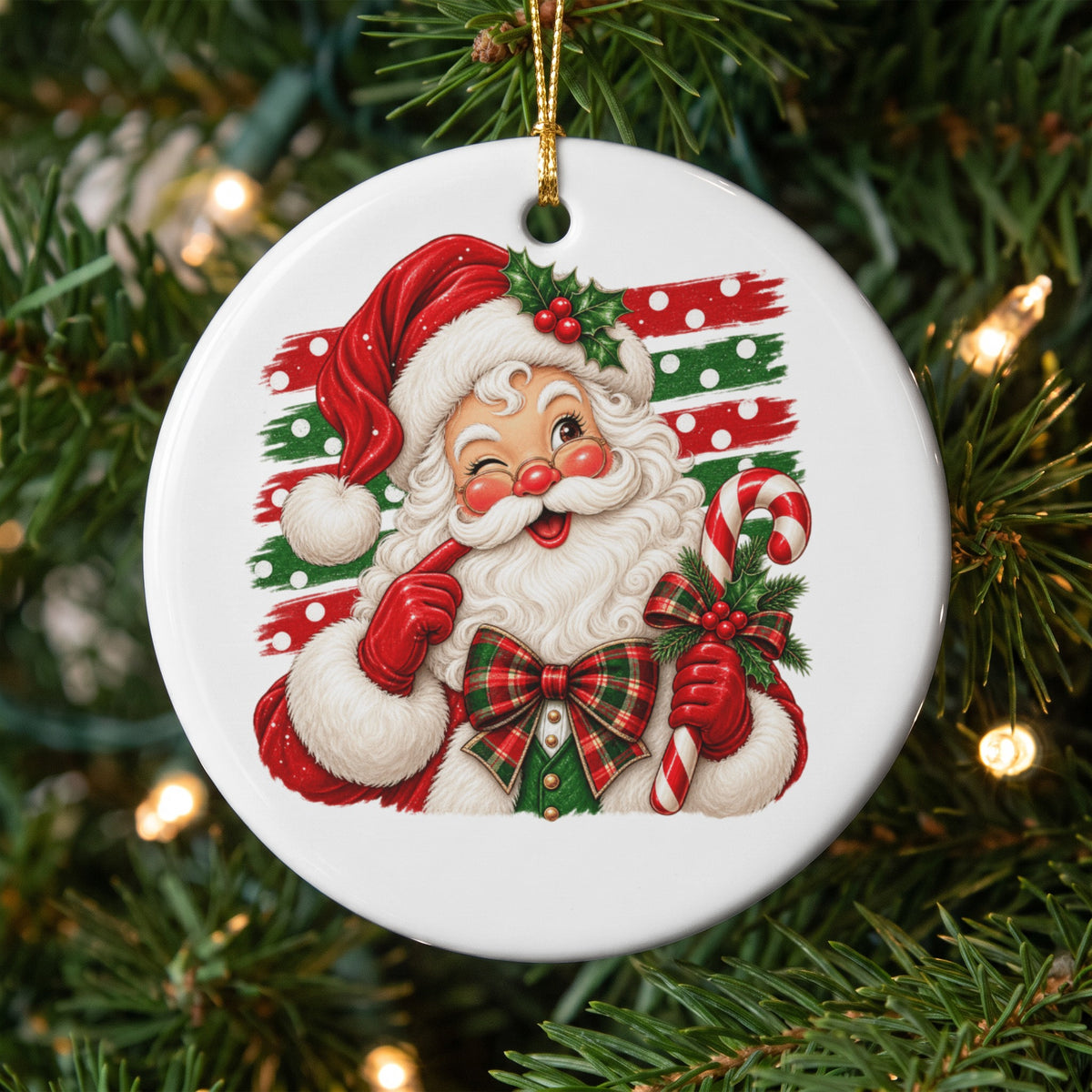 Circular ornament featuring a winking Santa Claus holding a candy cane with a plaid bow.