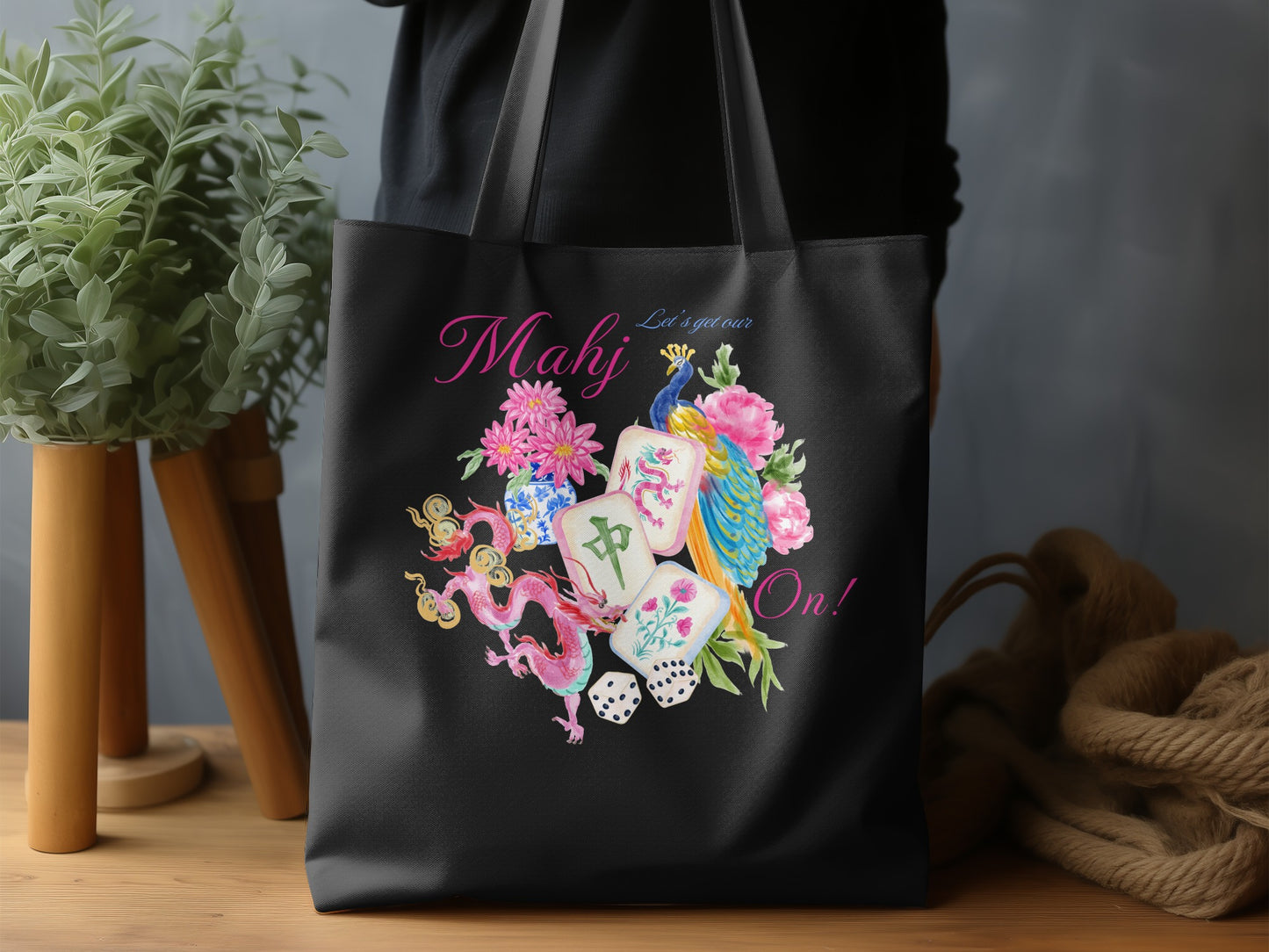 Black tote bag with "Mahj Let's get our On!" and mahjong tile design.