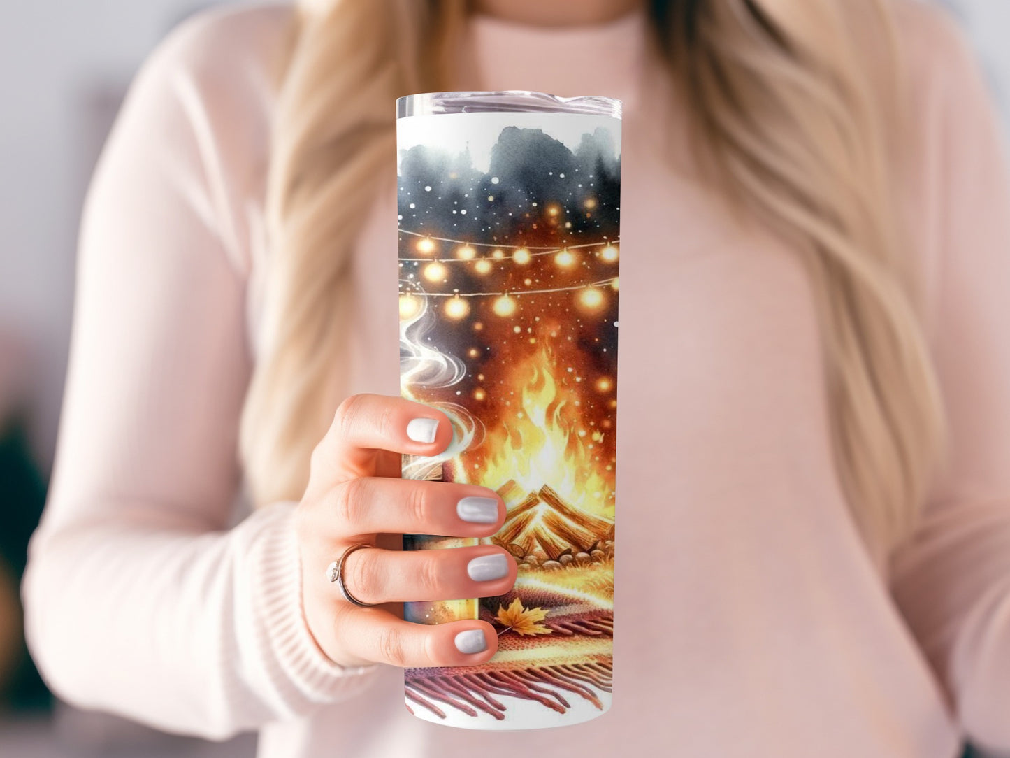 Tumbler with a cozy campfire and string lights illustration.