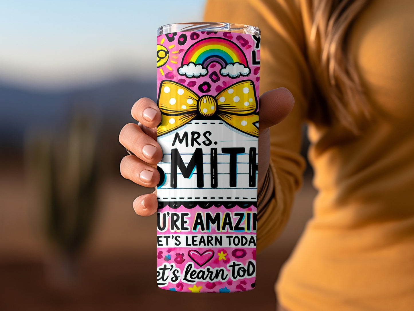Personalized "Mrs. Smith You're Amazing Let's Learn Today" tumbler with rainbow and polka dot design.
