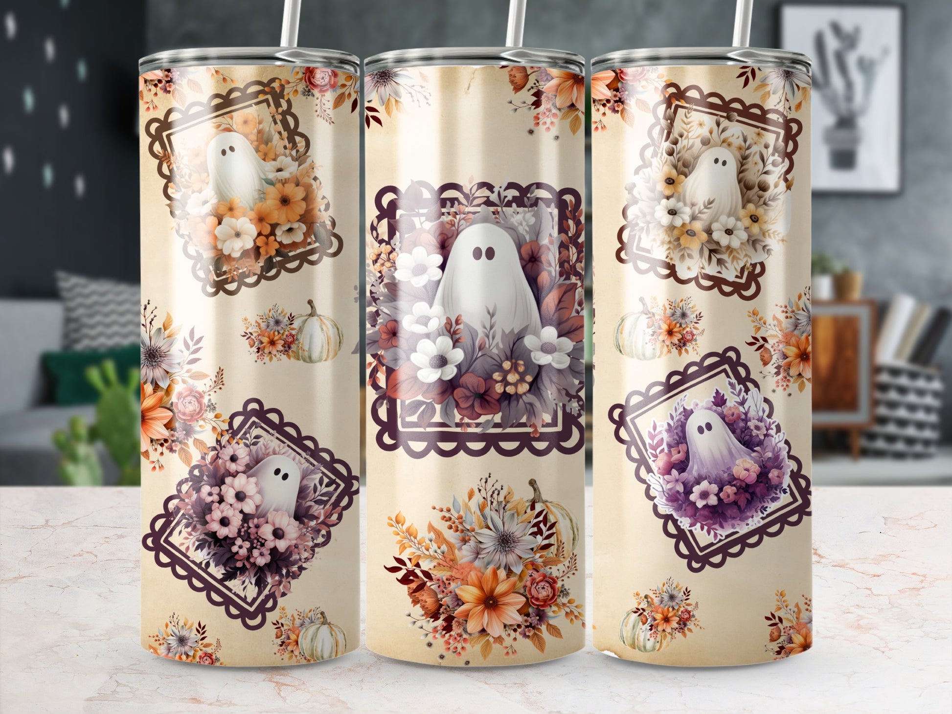 Three tumblers with ghost and floral Halloween designs.