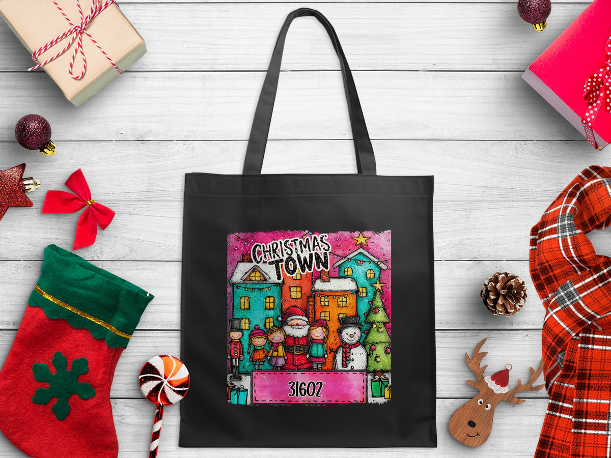 Black tote bag with a "Christmas Town" design featuring Santa, children, snowman, and the number 31602.