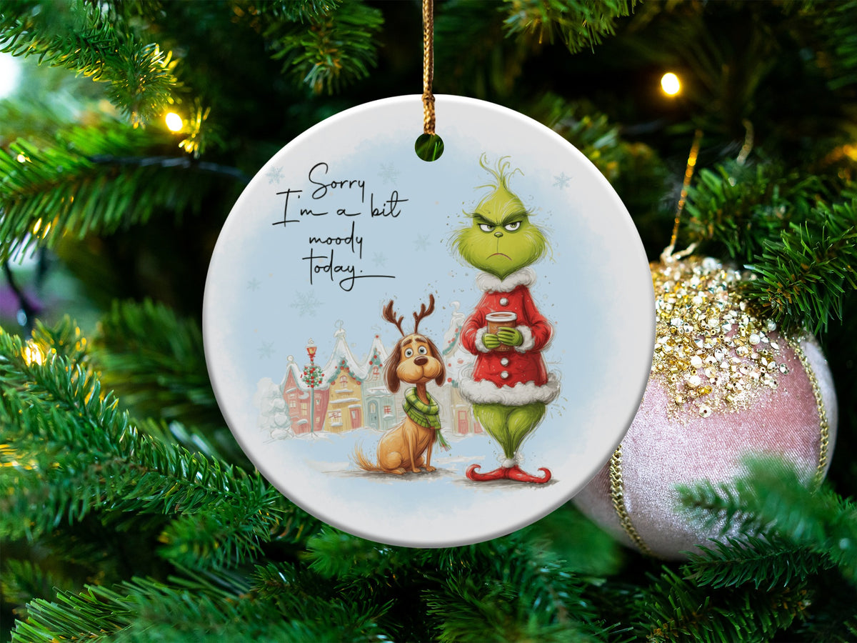 Round Grinch ornament with Max the dog, winter village, and text "Sorry I'm a bit moody today."
