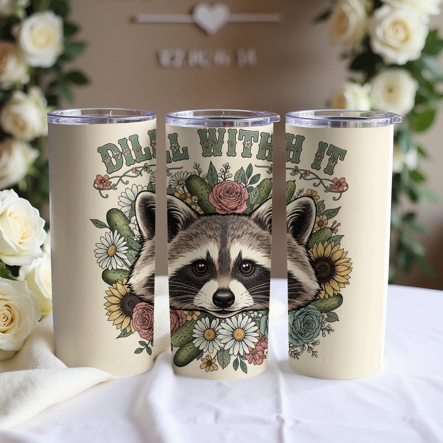 Floral raccoon tumbler with "dill with it" text.