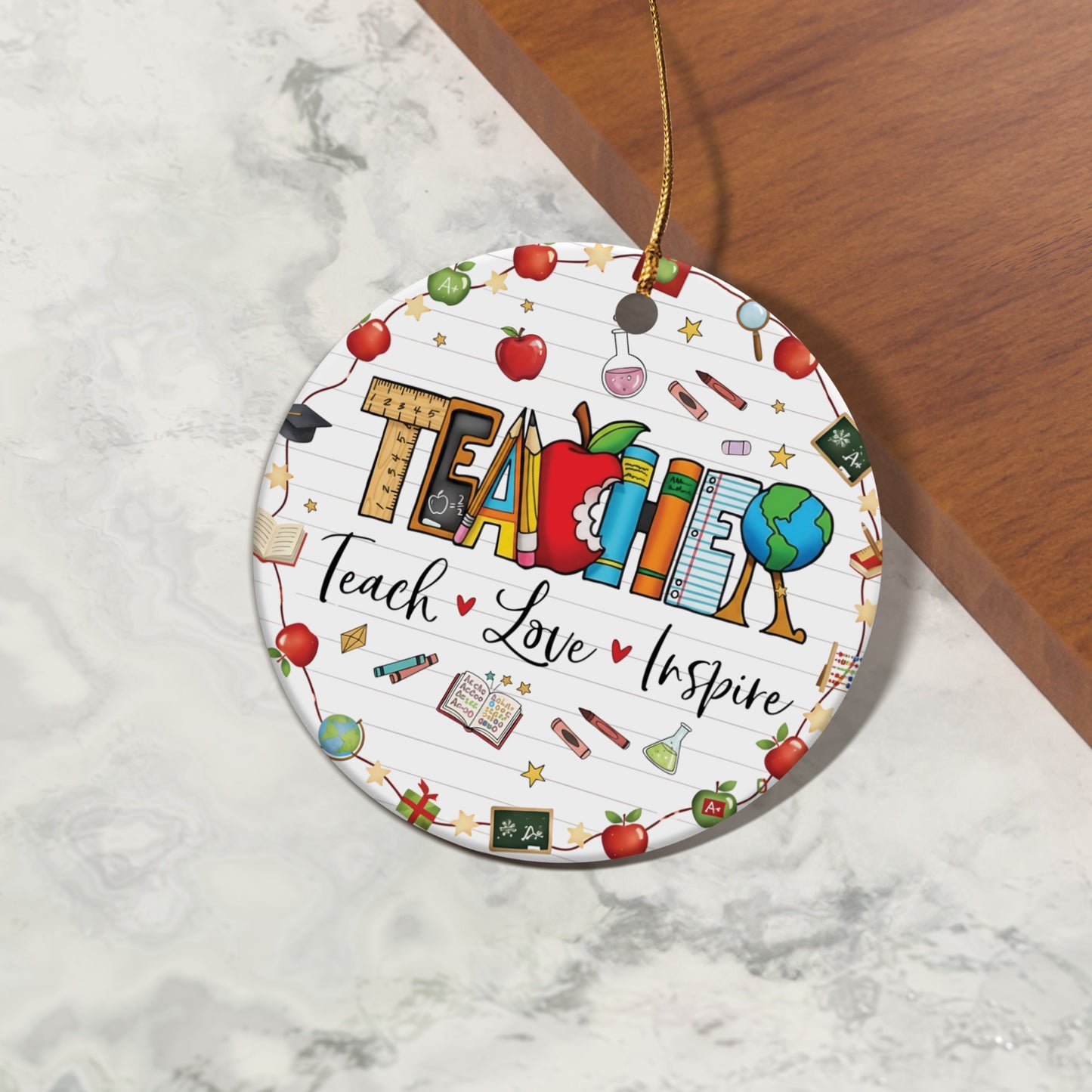 Circular ornament with "TEACHER" and "Teach Love Inspire" surrounded by school supplies.