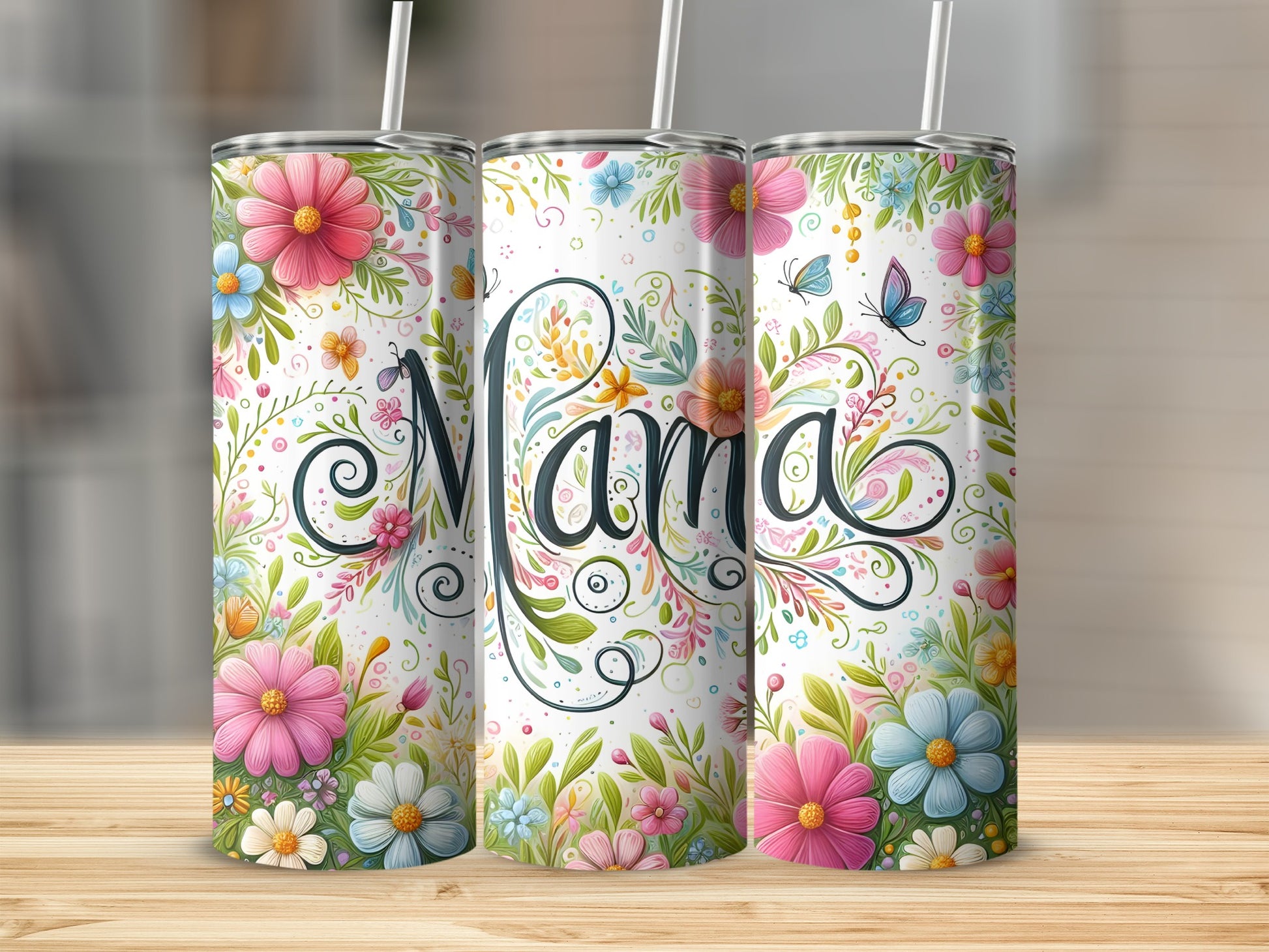Three floral tumblers with "Mama" script, on a wooden surface.