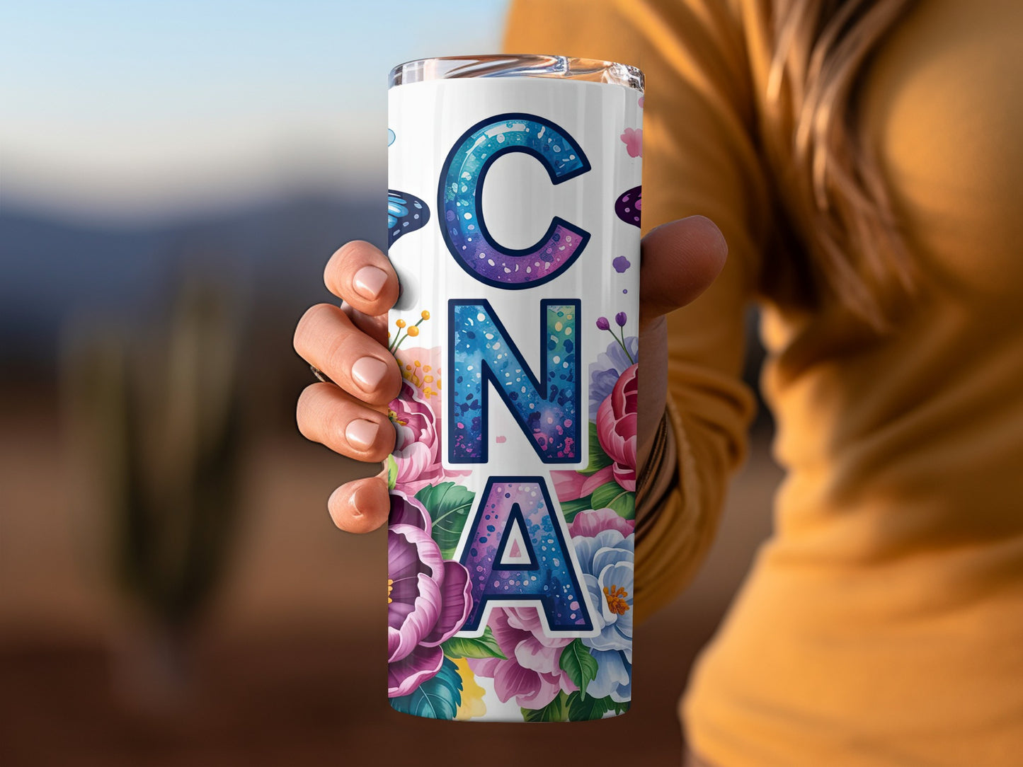 Tumbler with "CNA" spelled out in floral letters and butterfly accents.