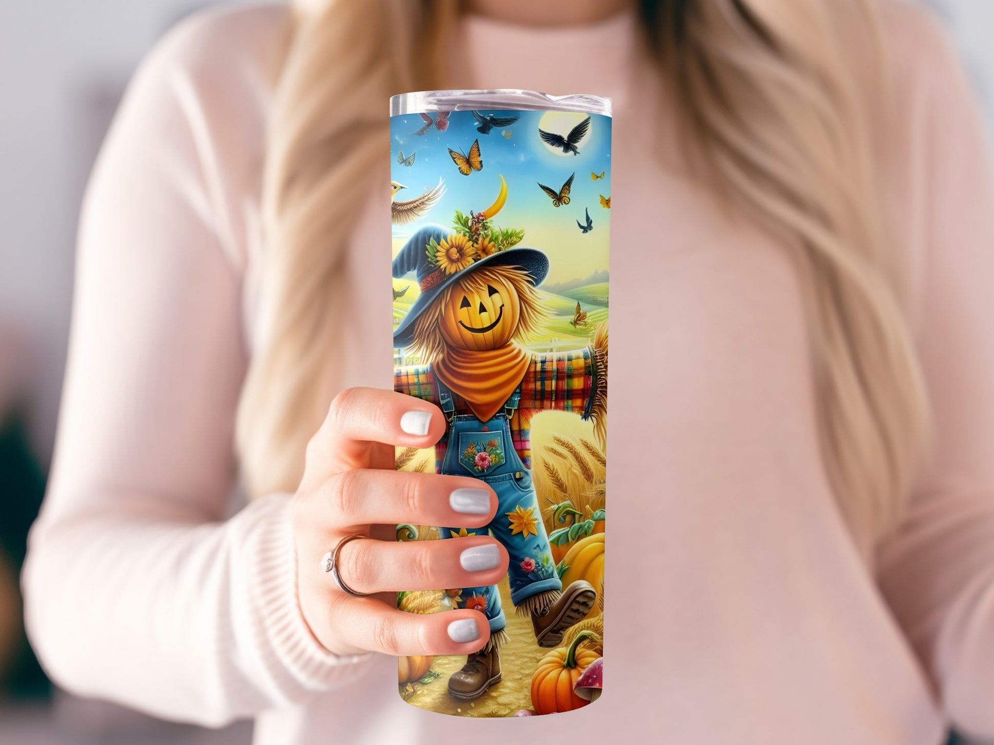 Tumbler with pumpkin scarecrow, butterflies, birds, moon, and autumn scene.