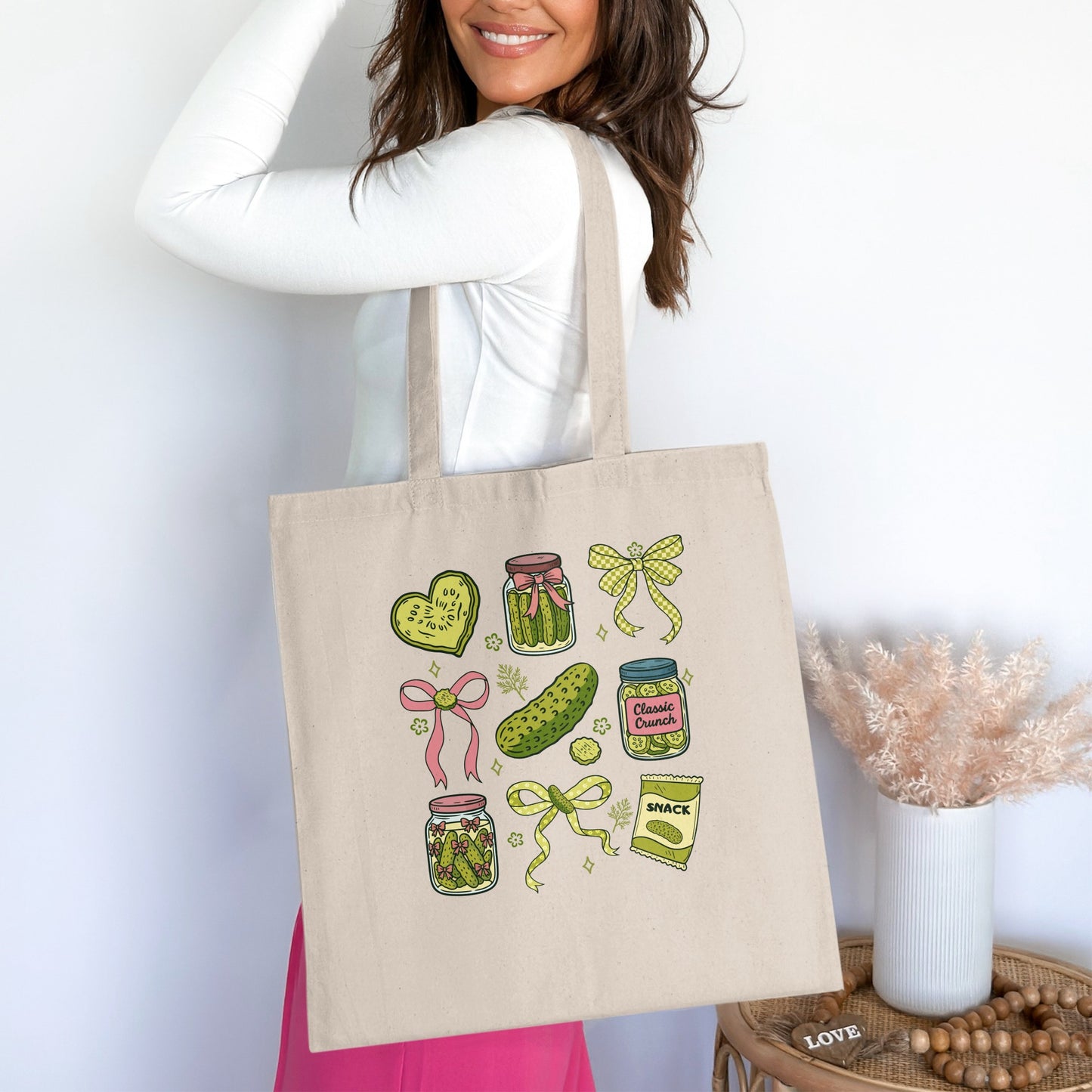 Tote bag with pickle jars, hearts, and bow illustrations.