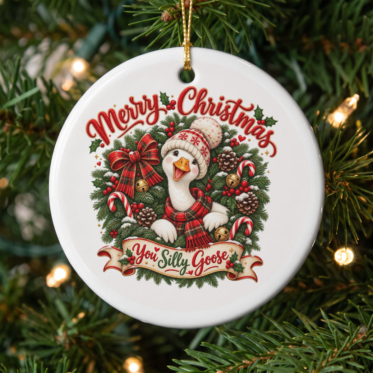 Merry Christmas ornament with a goose wearing a hat and scarf, surrounded by festive greenery.